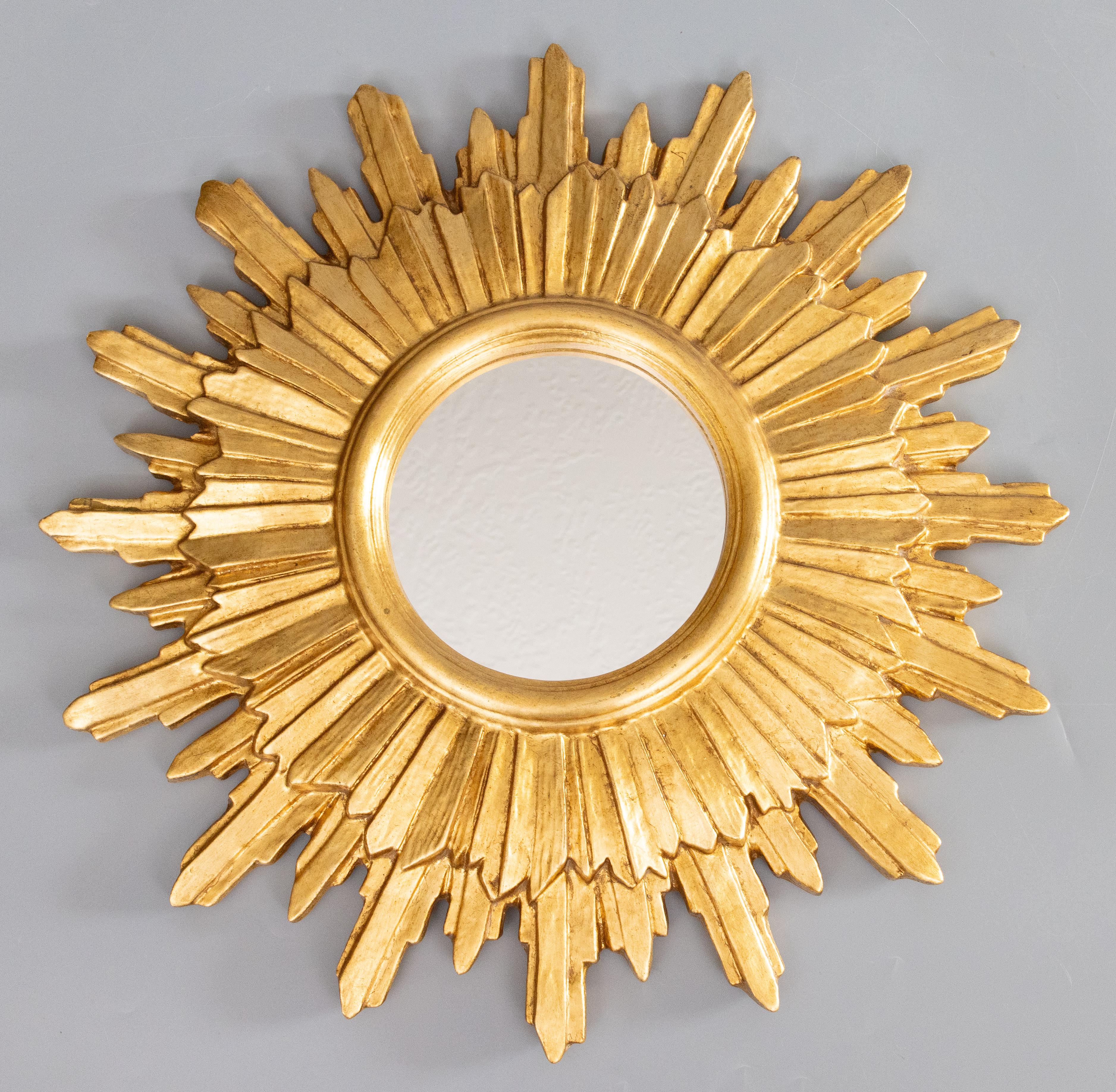 A stunning vintage Italian Florentine gilded wood and gesso sunburst mirror, circa 1950. Marked 