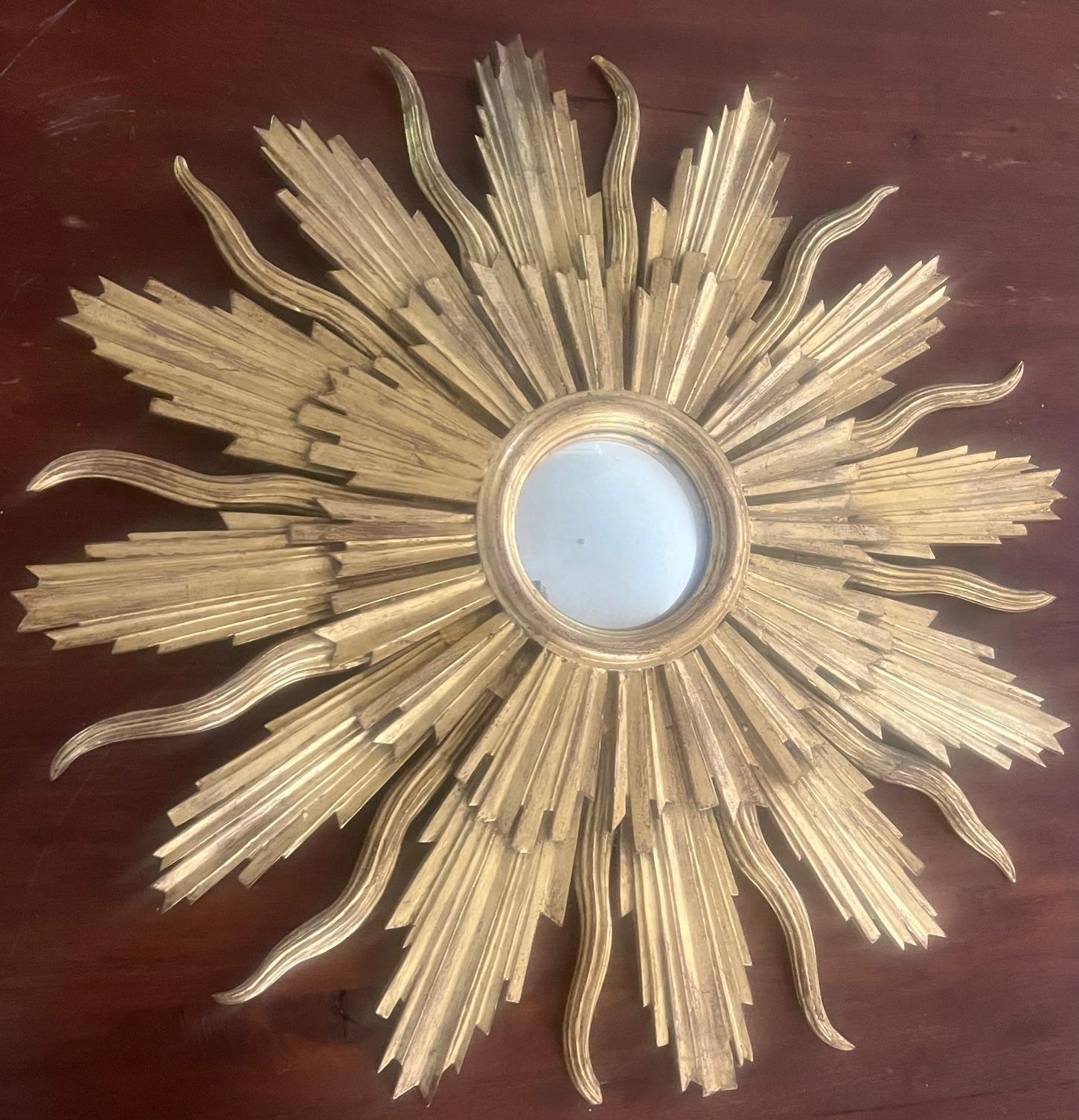 Miroir solaire en bois doré fabriqué en Italie au milieu du 20e siècle.  Des couches de rayons dépassent du centre rond et miroitant en lignes droites et sinueuses.
