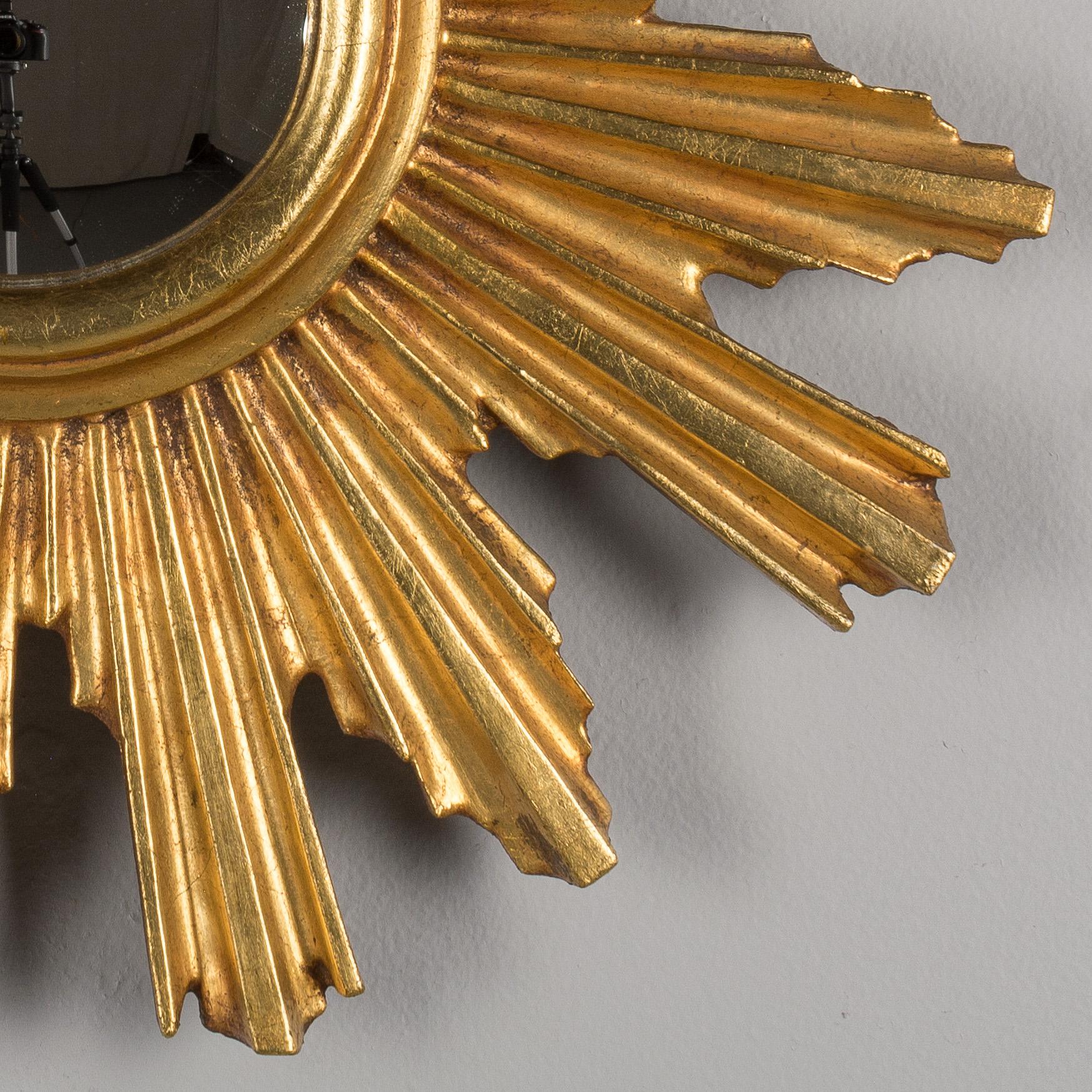 An Italian gilded wood sunburst with convex mirror.