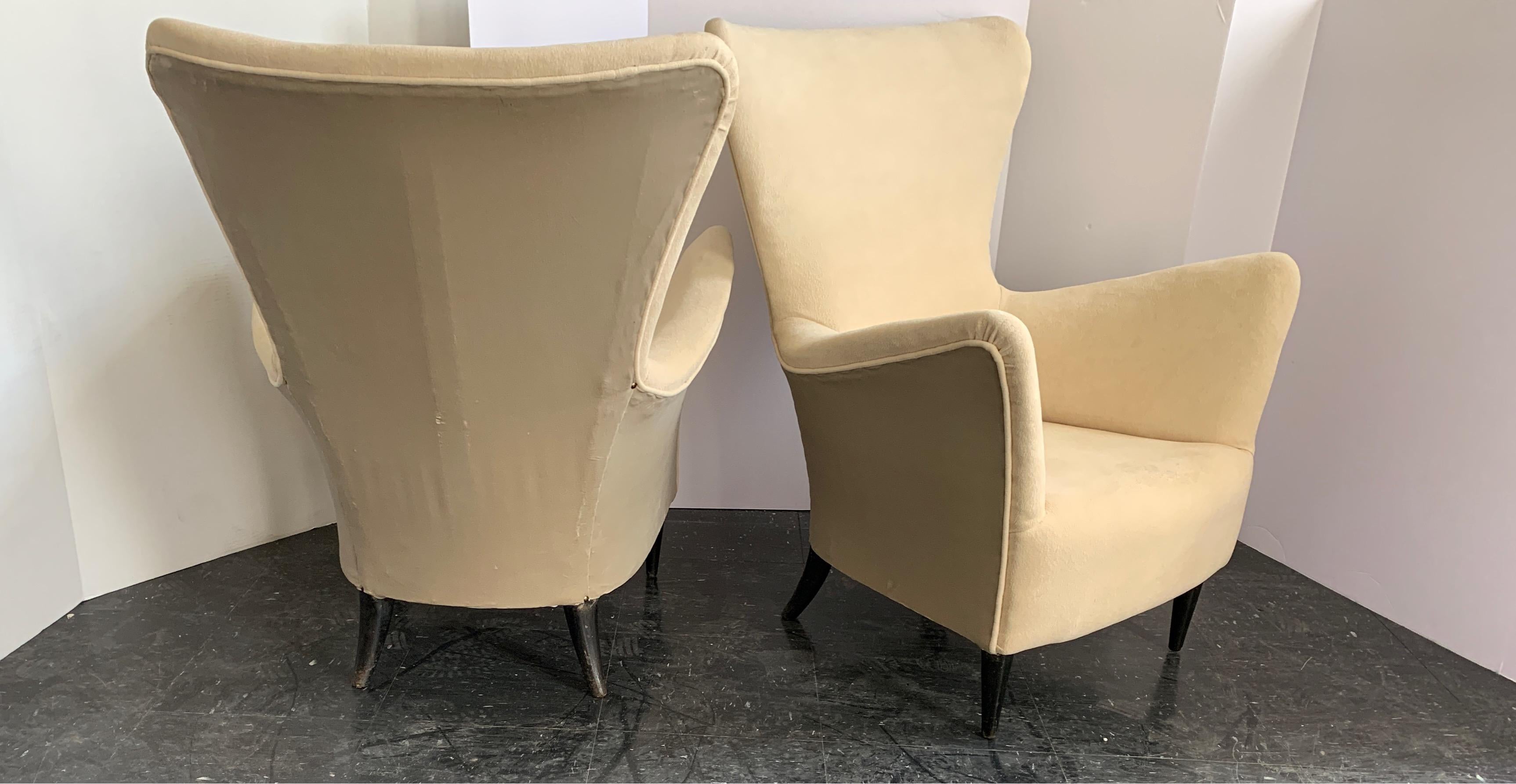 These 1960s Mid-Century Modern Italian chairs have all the comfort with tons of style. The are done in a two-tone fabric and the legs are a black painted wood. They do have scratches on the legs but overall in great condition. Gio Ponti was a great