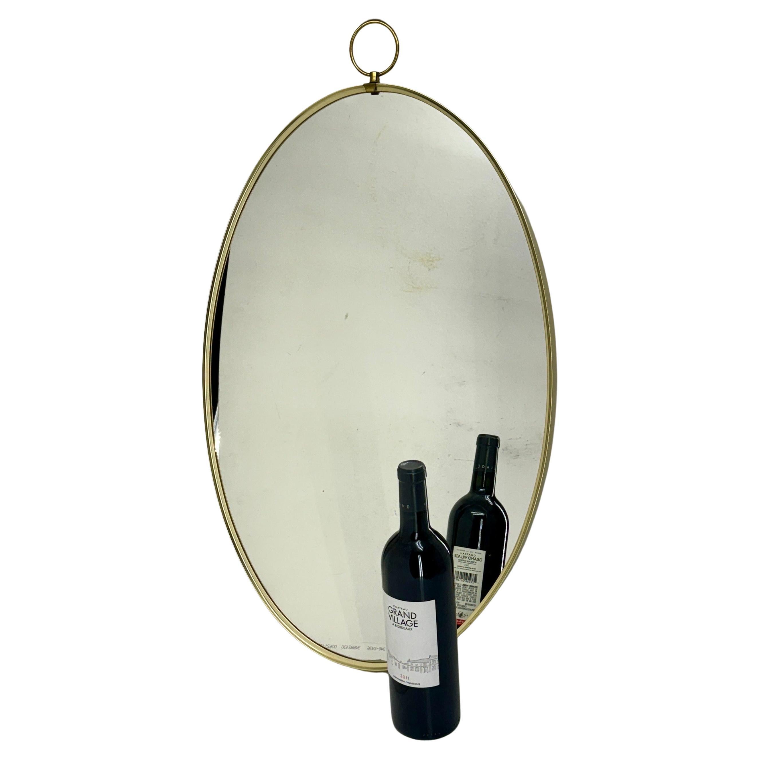 Italian Gio Ponti Oval Brass Wall Mirror Mid-Century Modern
 
Elegant vintage Italian oval brass wall mirror from the 1960s with original patina. Classic mirror which would bring timeless charm for an entry way, bathroom or bedroom. 
