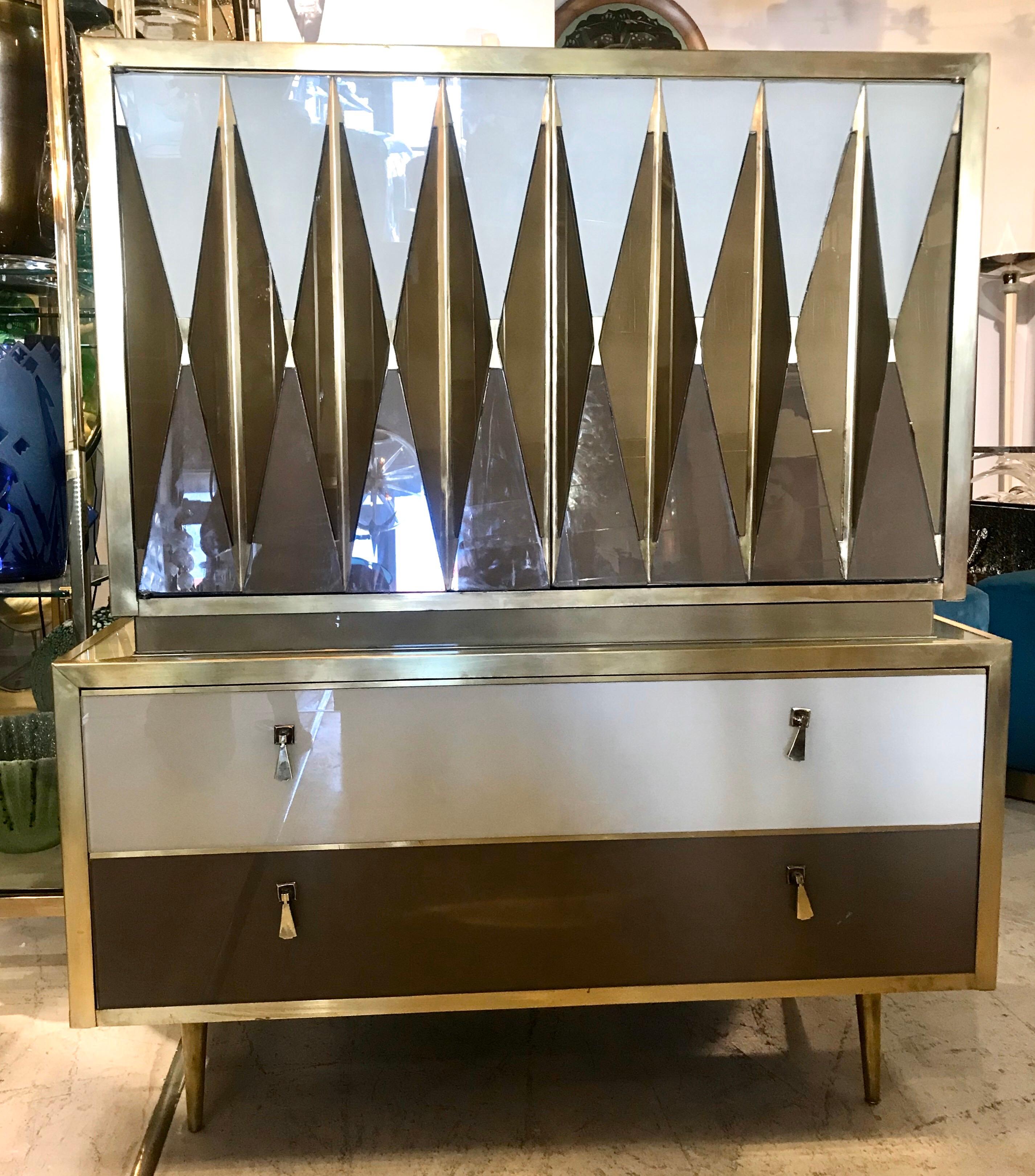 One of a kind, custom made Italian chest of drawers of glass and brass. This highly decorative piece of furniture enhances any room it's placed in.