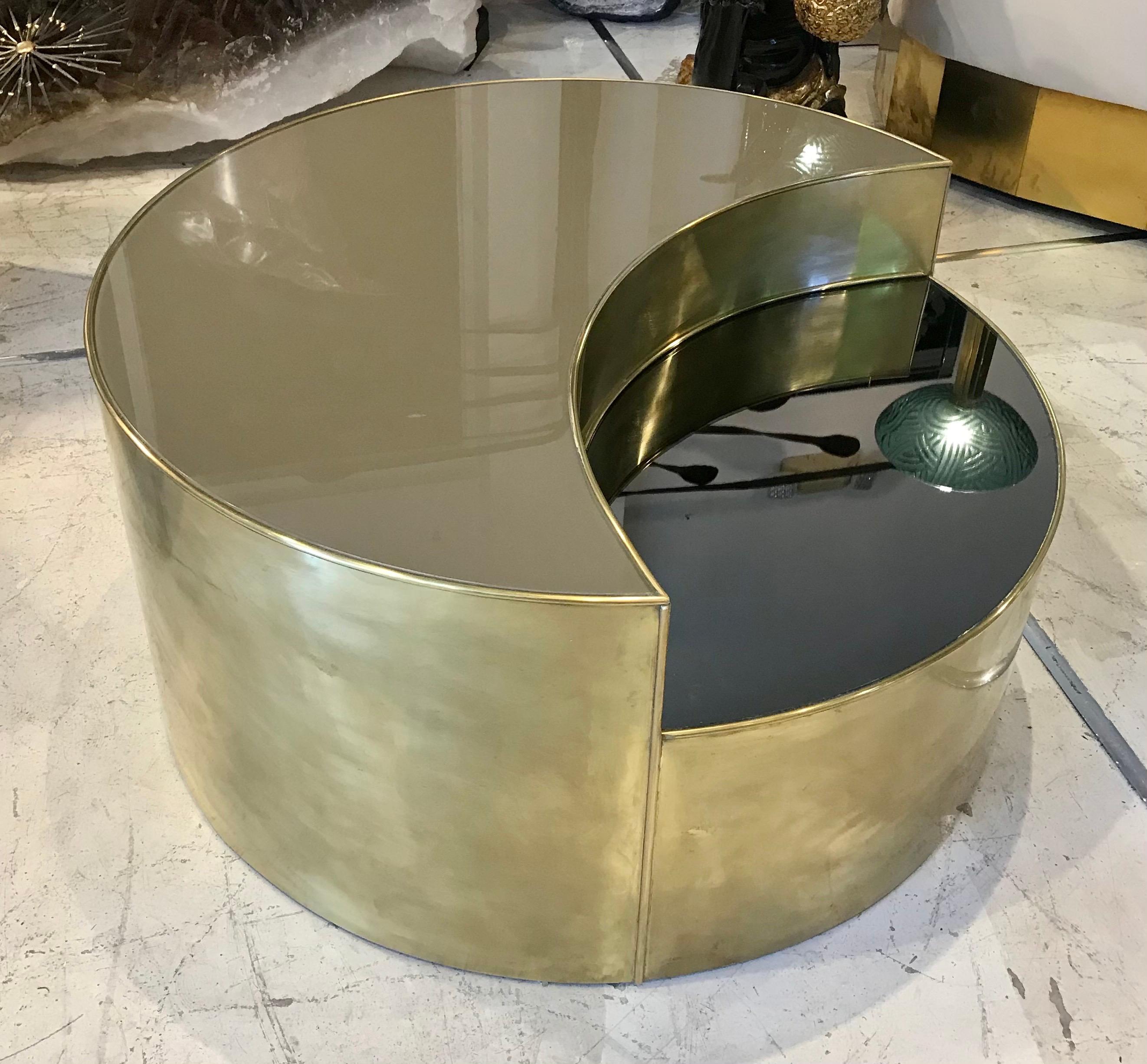 Mid century Italian reverse painted glass, brass and mirror create a circular hi/lo coffee table.