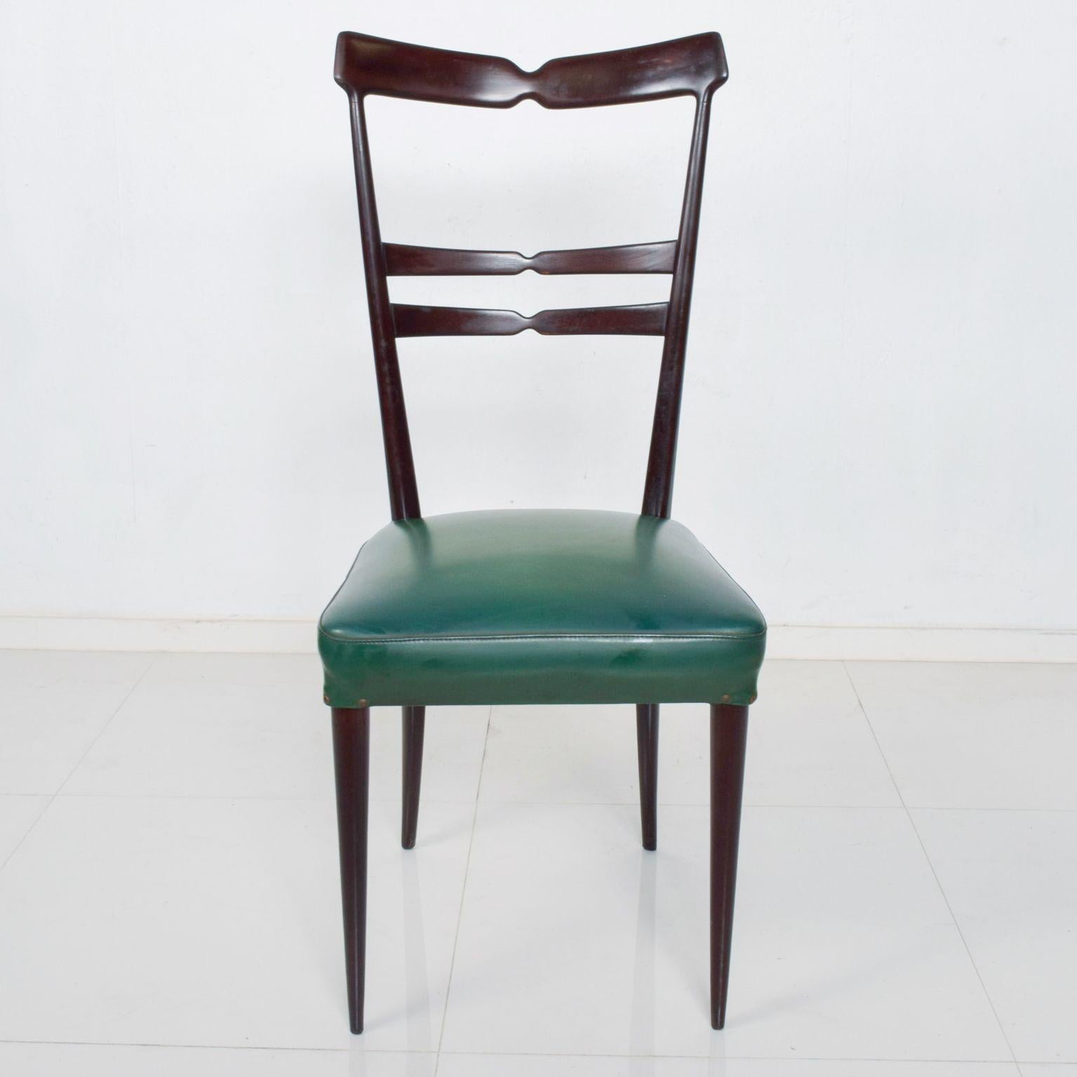 Green Naugahyde Italian Dining Chairs
Set of Six Dining Chairs in green after ICO PARISI. 
Made in Italy circa the 1950s.
Wood with dark mahogany finish. 
Original green Naugahyde. 
Firm and sturdy.
Price is per set of 6 chairs only. 
We are