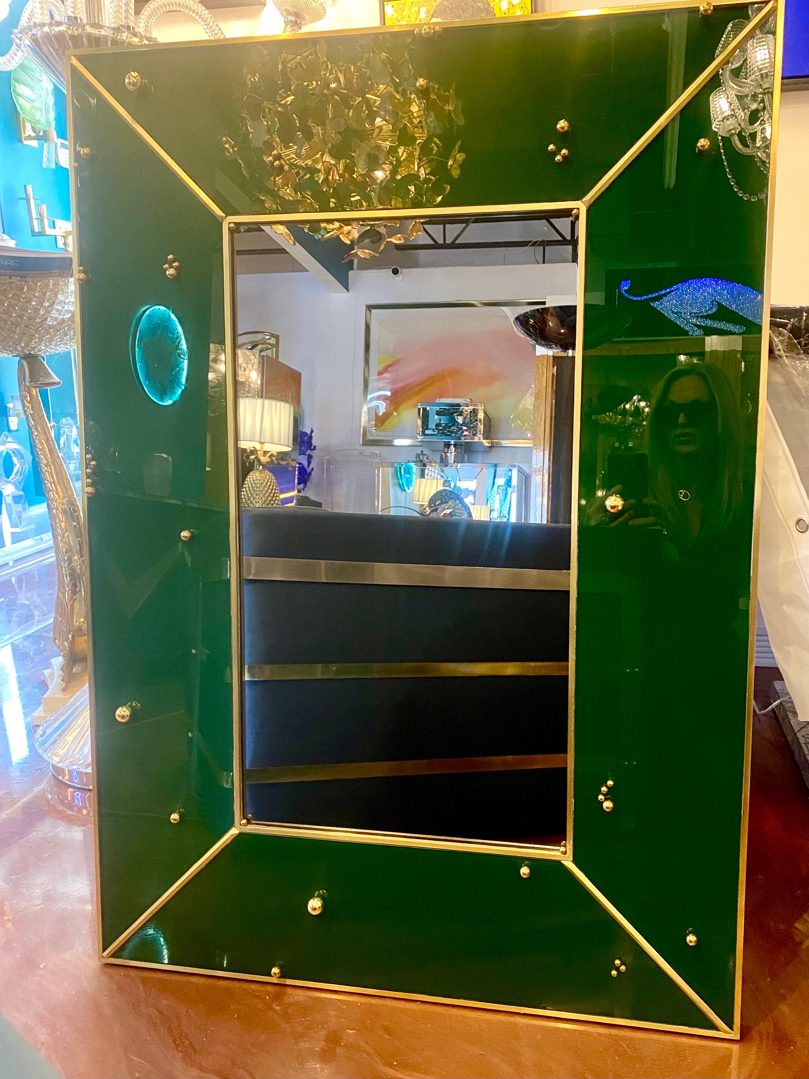 A Unique Italian Emerald Green Reverse Painted Glass Mirror with Brass Trim and Brass Sphere Bead Decor on the Frame. 