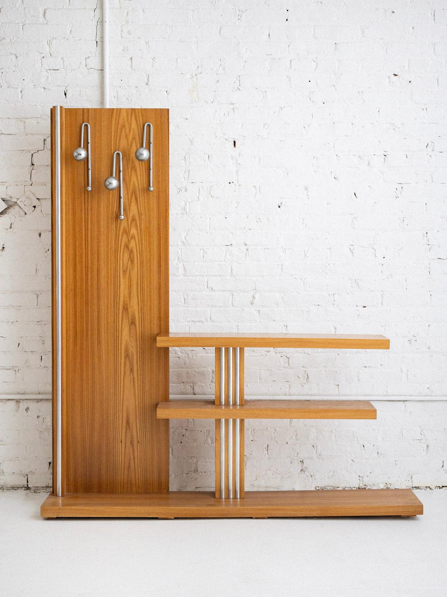A free standing mid century Italian “hall tree” or coat rack. Blonde wood and chrome details. Two shelves for storage. Chrome coated plastic hooks. Sourced in Northern Italy.