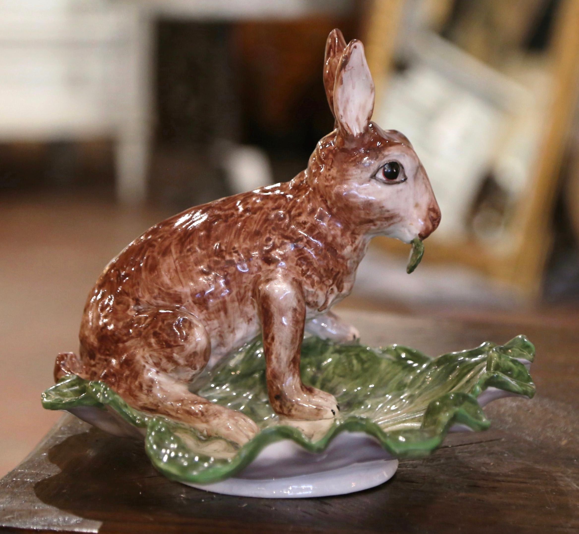 Decorate a table or console with this colorful vide-poche dish. Created in Italy circa 1970, this elegant dish shaped as a large leaf with scalloped edges, features a cheerful rabbit sited on its back legs and eating. The decorative platter is in