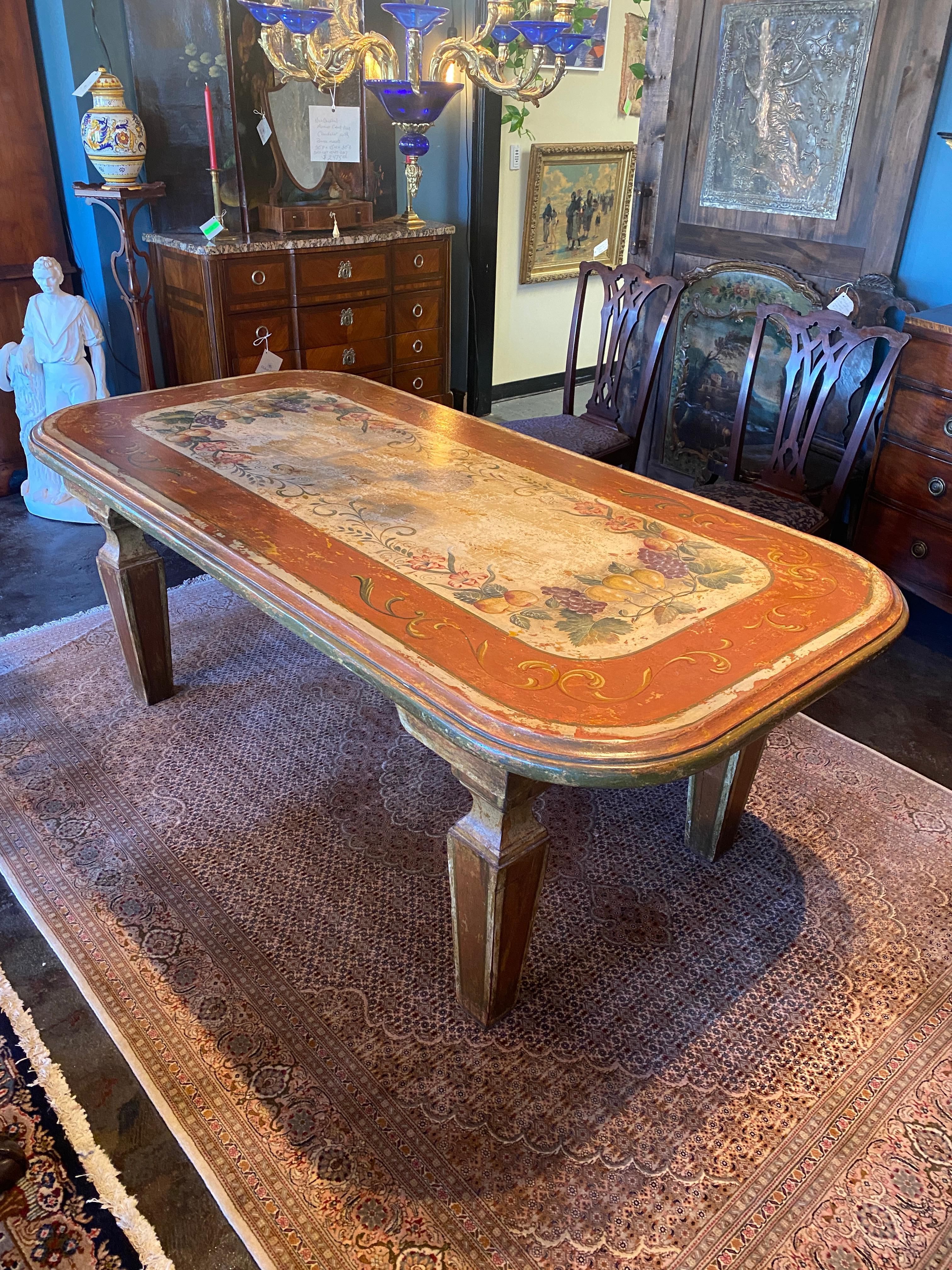 Large one piece top mid-century Italian hand painted table. Good patina on the surface, Hand painted scroll, grape and pear design. Four large removable legs.