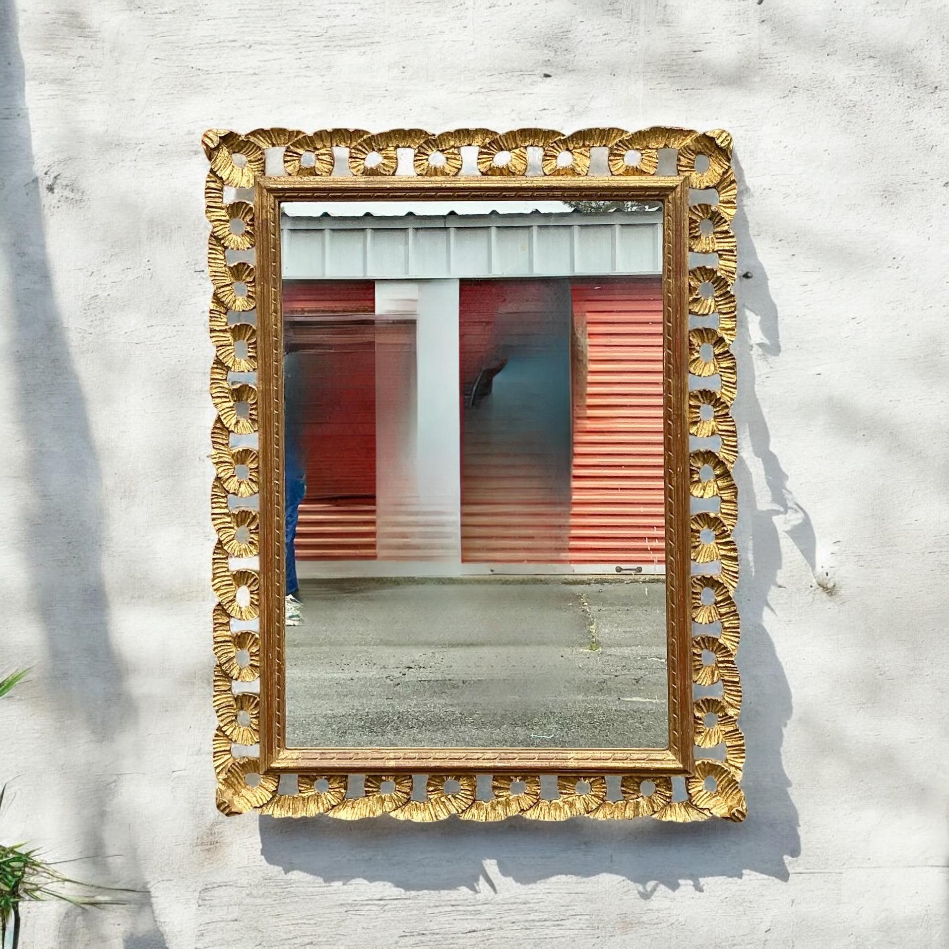 This is a lovely 1960s Hollywood Regency era carved giltwood ribbon mirror. It is unmarked and can be hung either vertically or horizontally. Nice size for that hall bath! It is in very good condition.