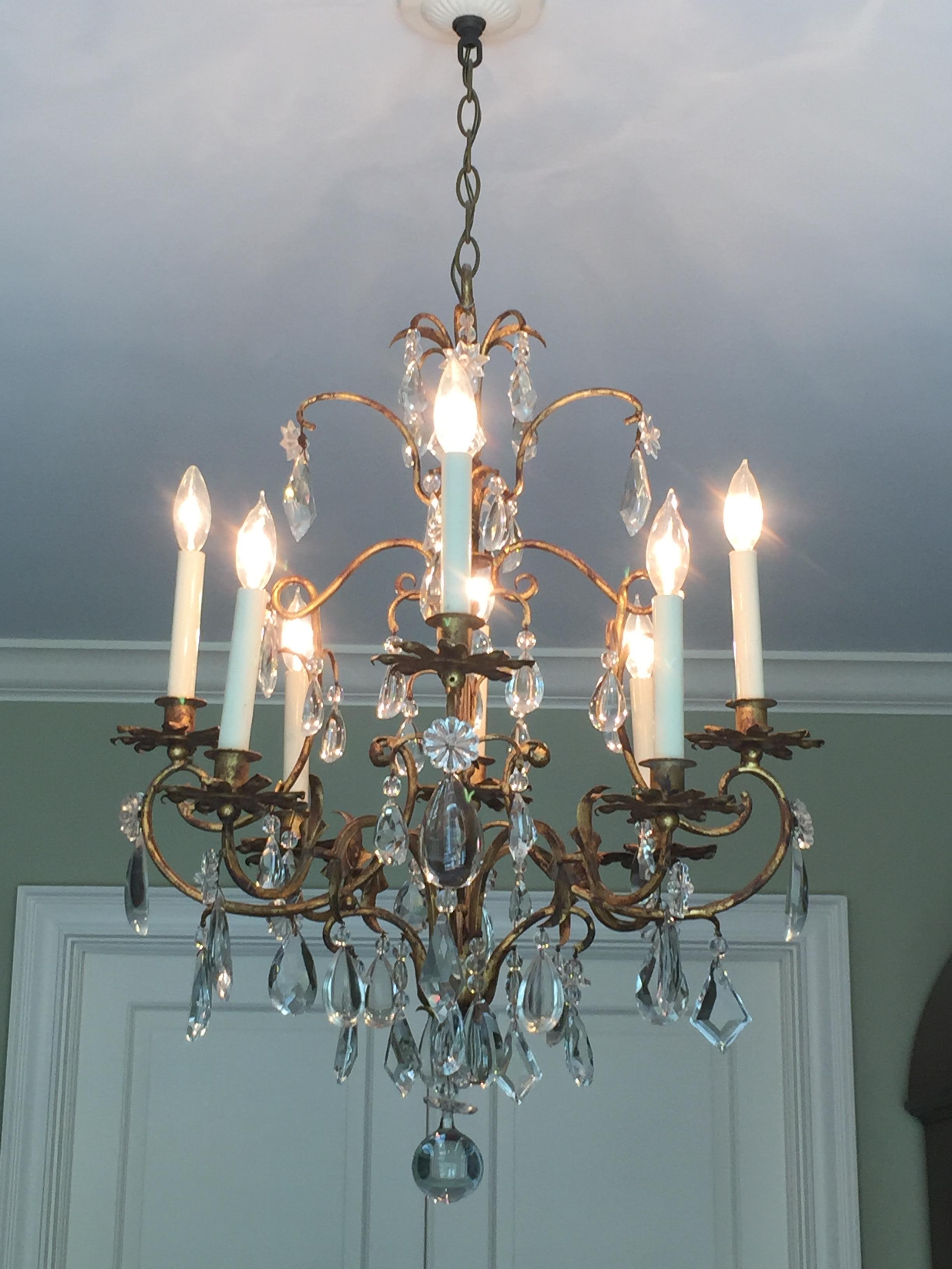 Mid-Century Italian iron and crystal chandelier with rich patina. Wired for use within the USA. We found this in a shop in Italy; fell in love, and had it crated and shipped home. It added another elegant layer to our dining room. But would be