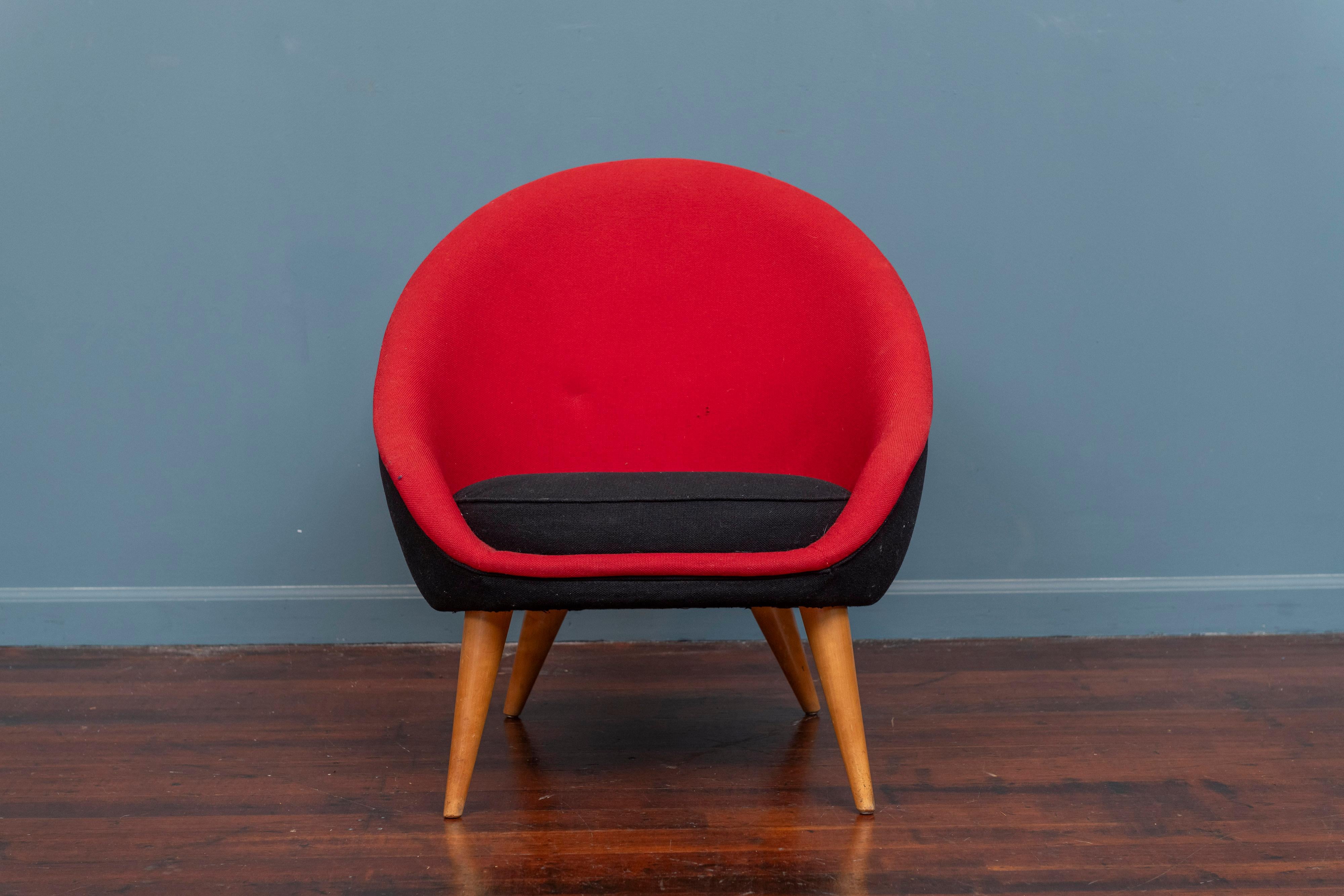 Mid-Century Italian made lounge chair. Petite and compact lounge chair upholstered in a bold black and red wool blend on birch legs. Aesthetically pleasing and inviting this chair is perfect for a small bedroom or nook. In good structural condition