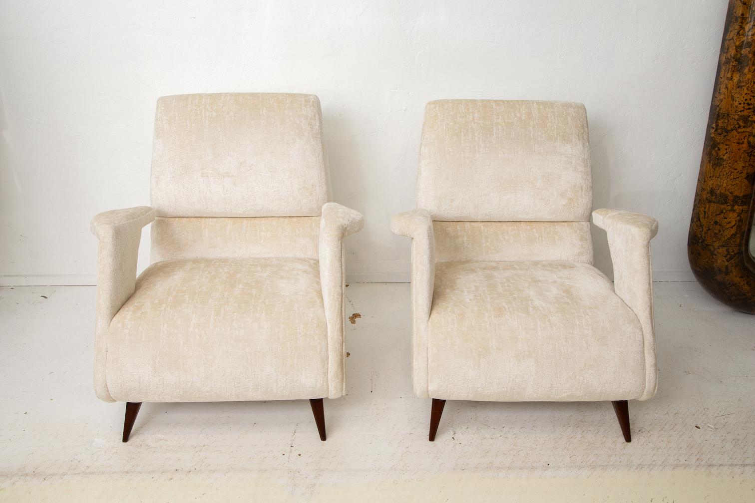 Stunning pair of mid-century Italian lounge chairs in the manner of Ico Parisi. Newly upholstered in a soft and velvety chenille.