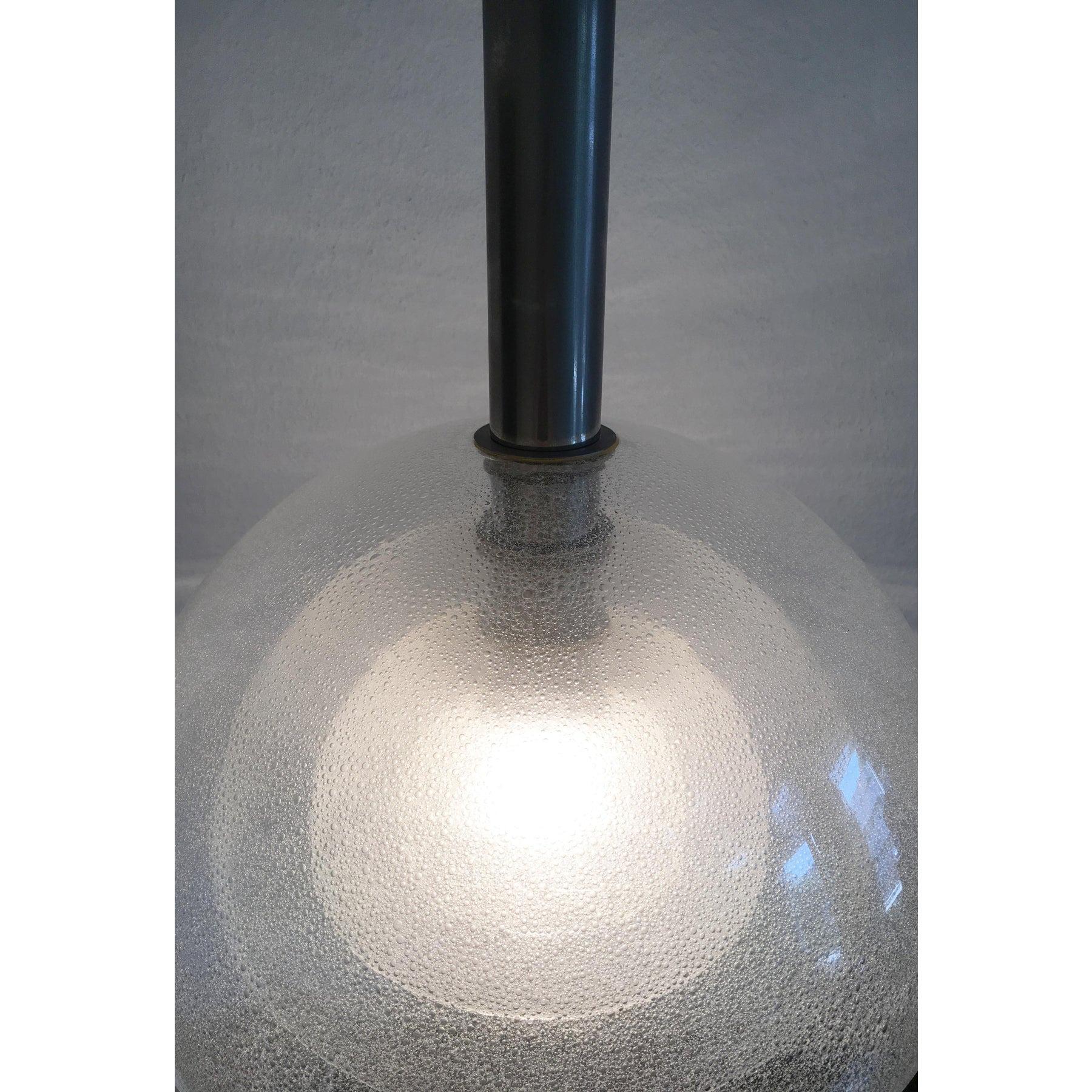 Imposing pendant from the Italian manufacturer Mazzega based on a design by Carlo Nason from the 60s.

This pendant lamp impresses with precision, design language and materiality. It consists of 4 veschieden large domes of Murano glass with a
