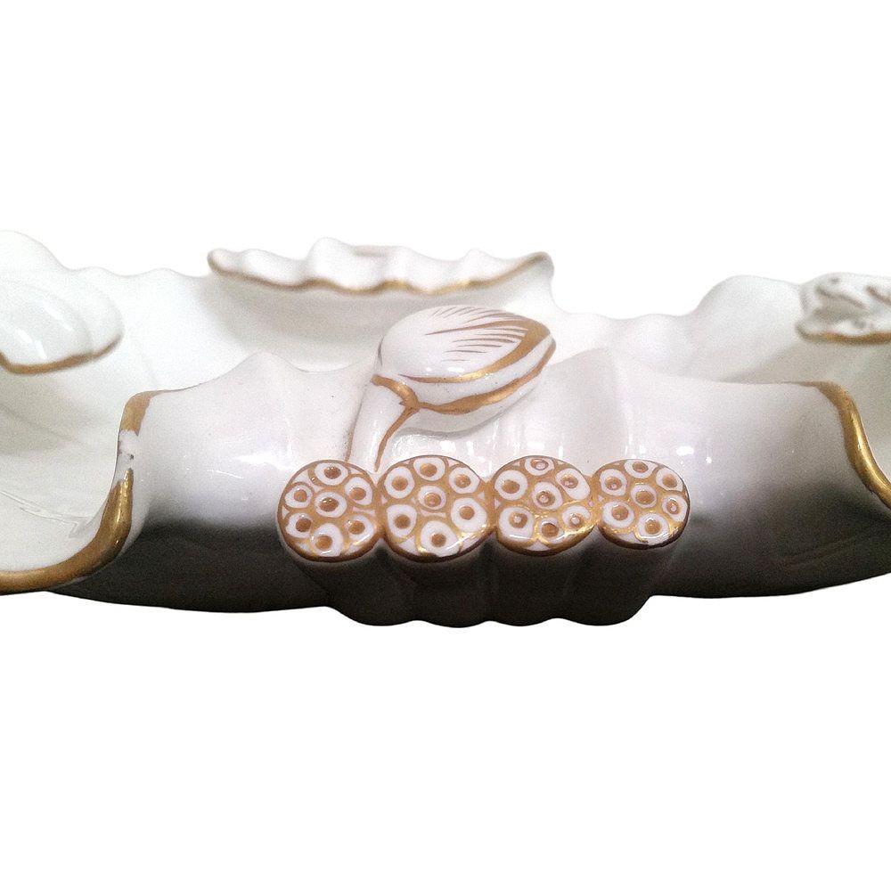 Mid-century era ashtray is made of fine Italian glazed porcelain, with 24 karat gold gilded details. It depicts a turtle on a floating lotus pad. The bottom of the bowl is sufficiently detailed that the piece can be displayed empty, or it could be
