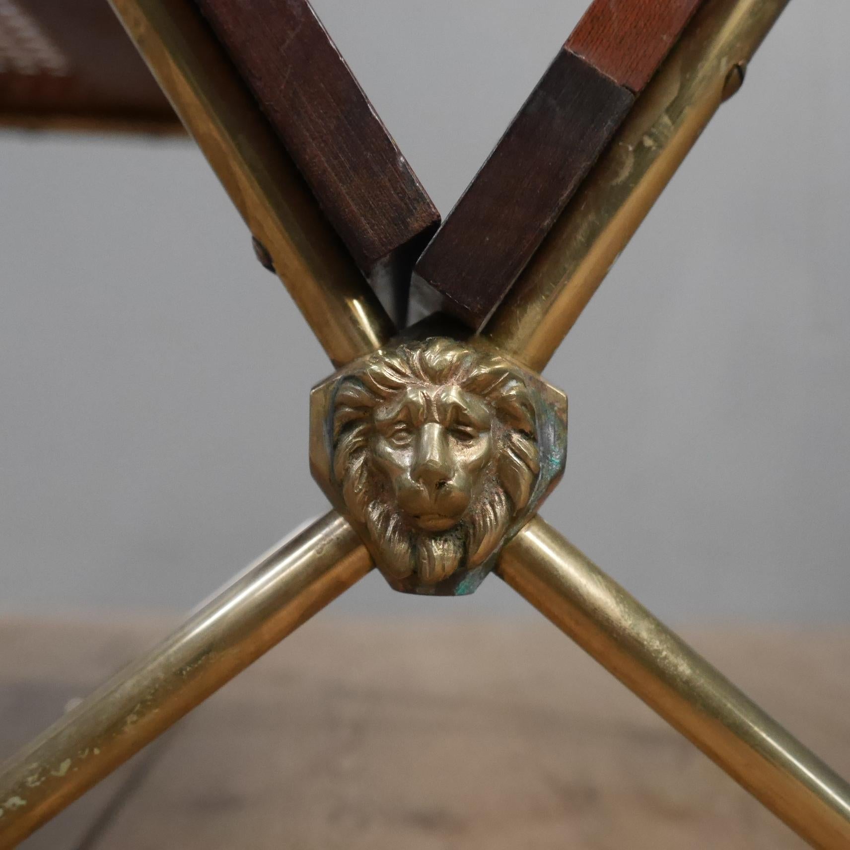 An Italian magazine rack / side table.
An elegant, stylish & extremely unusual magazine rack, the gilt brass frame with arrow feet & finials supporting caned solid hardwood panels & with lion masks flanking the base.
A handsome, high quality piece