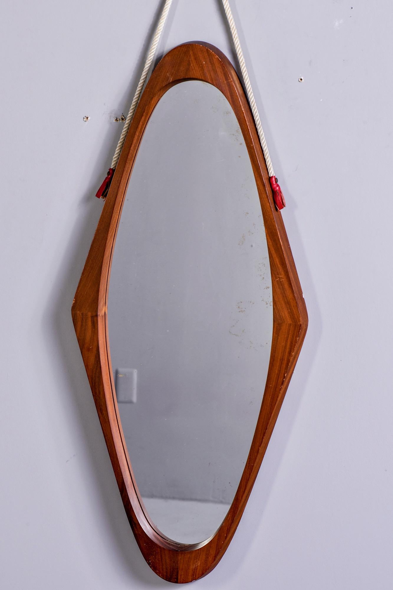 Circa 1970s Italian tall, narrow oval mirror with mahogany frame and rope hanger. Unknown maker.
Actual mirror size: 31” H x 11.5” W
Rope adds 8” to height when hanging.