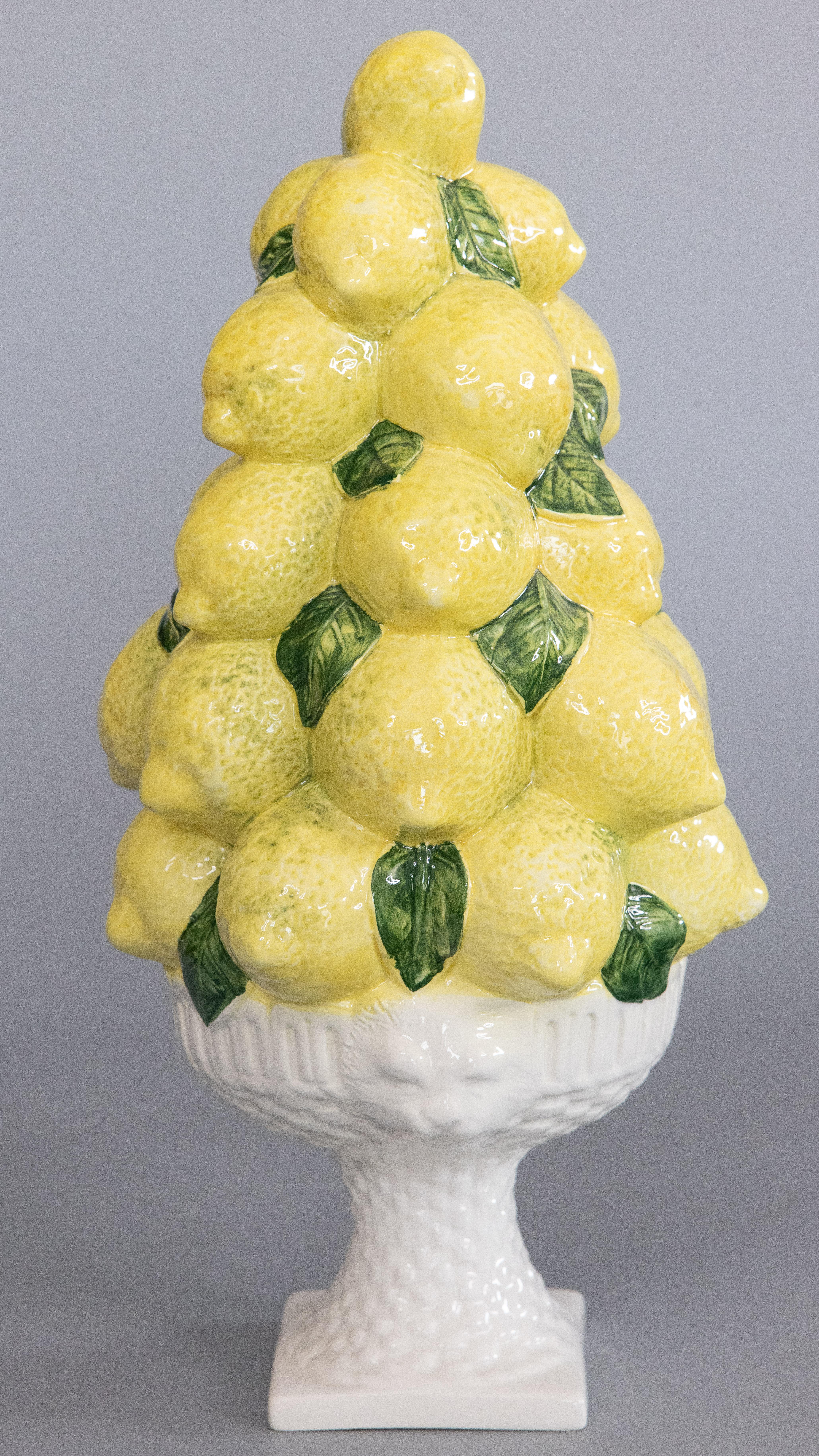 A lovely vintage Mid-Century Italian majolica lemons topiary centerpiece on an ornate white pedestal with lion heads. Signed 