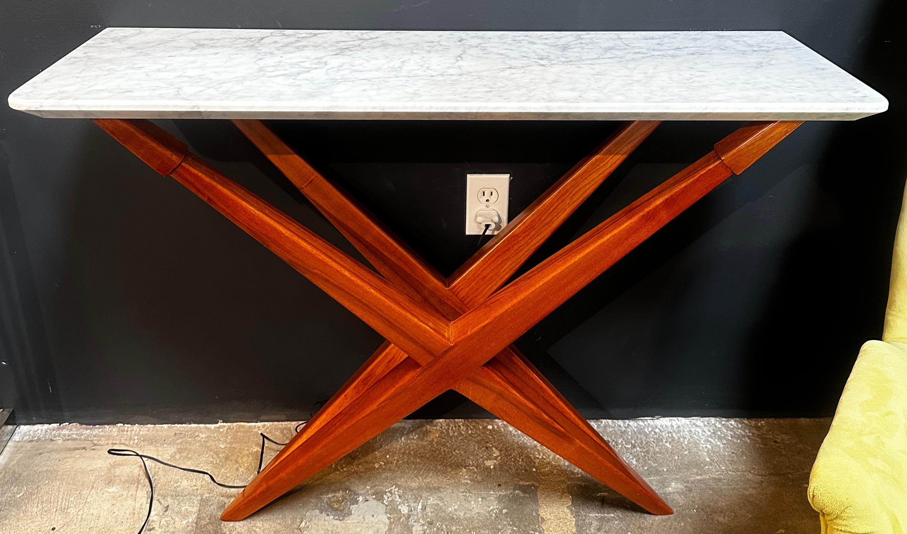 This beautiful console table is made from solid walnut wood pieces forming this wonderful architectural design. The console is topped by a thick white marble. A very high quality piece of hand made furniture with great details.