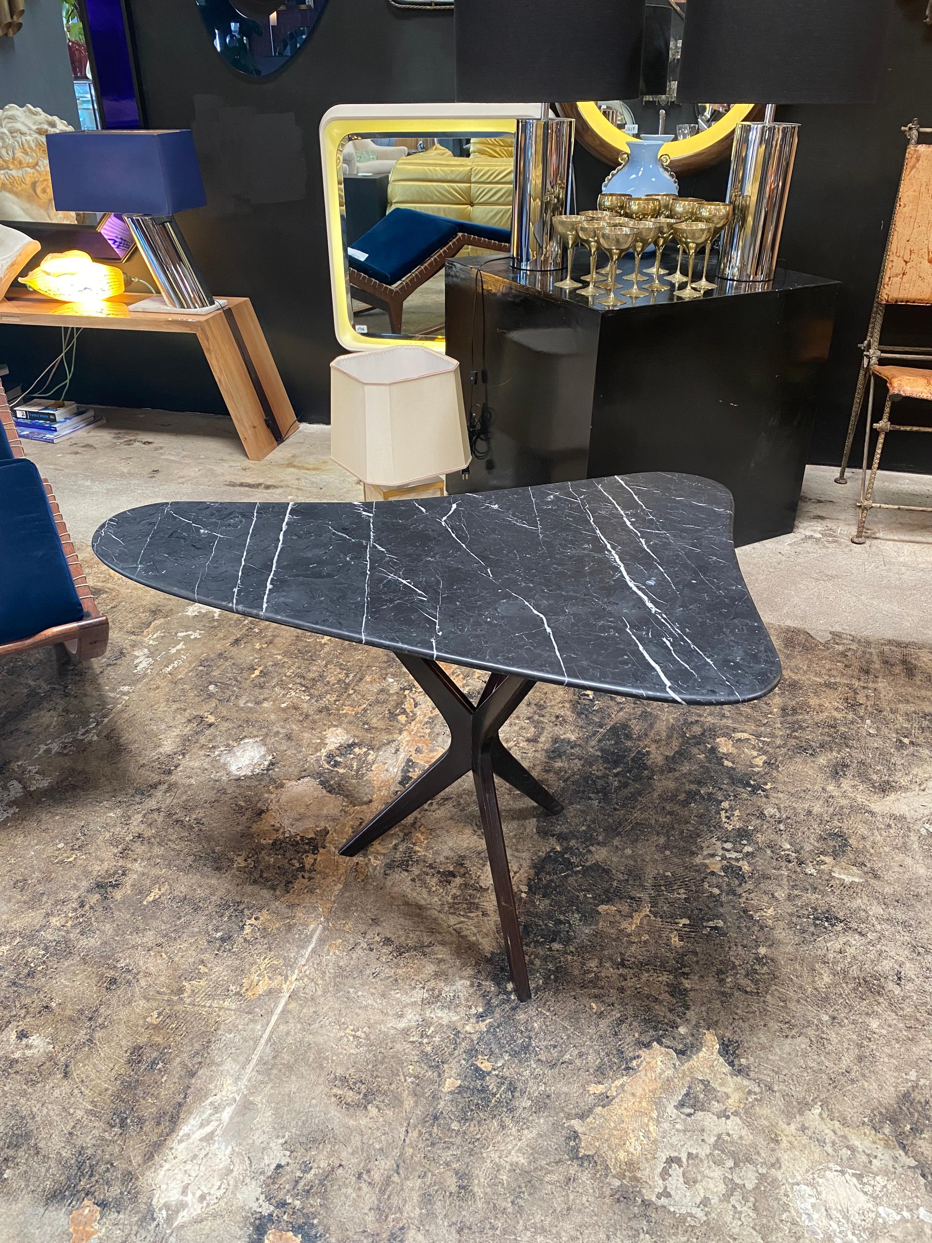 Stunning coffee table with wood base and black marquina marble top. A very elegant piece that will give some touch in the room.
