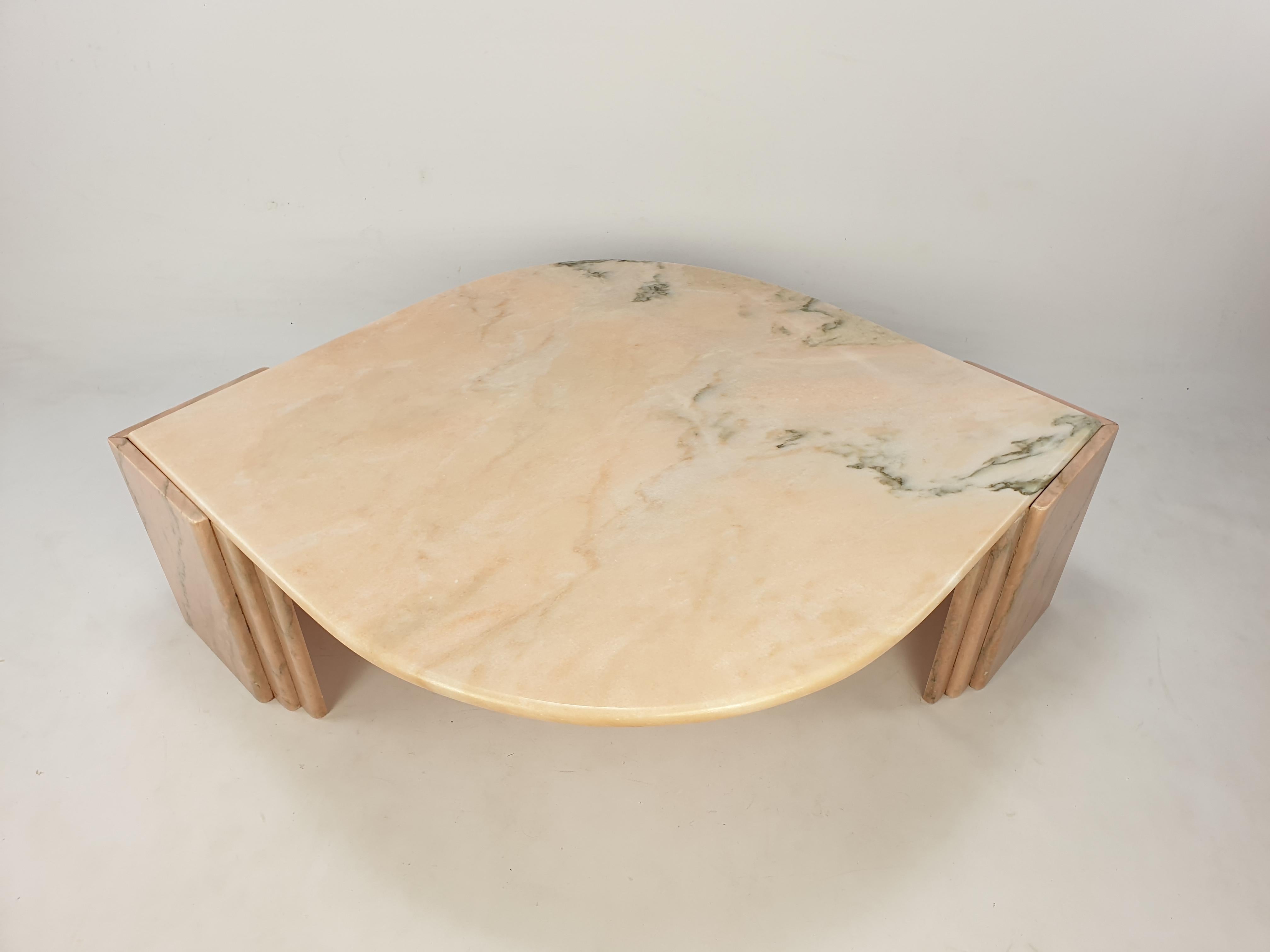Very elegant Italian coffee table handcrafted out of lovely colored pink marble. The beautiful teardrop shaped top is rounded on the edge. The base is made of two separate pieces. This stunning table will make the perfect addition to any seating or