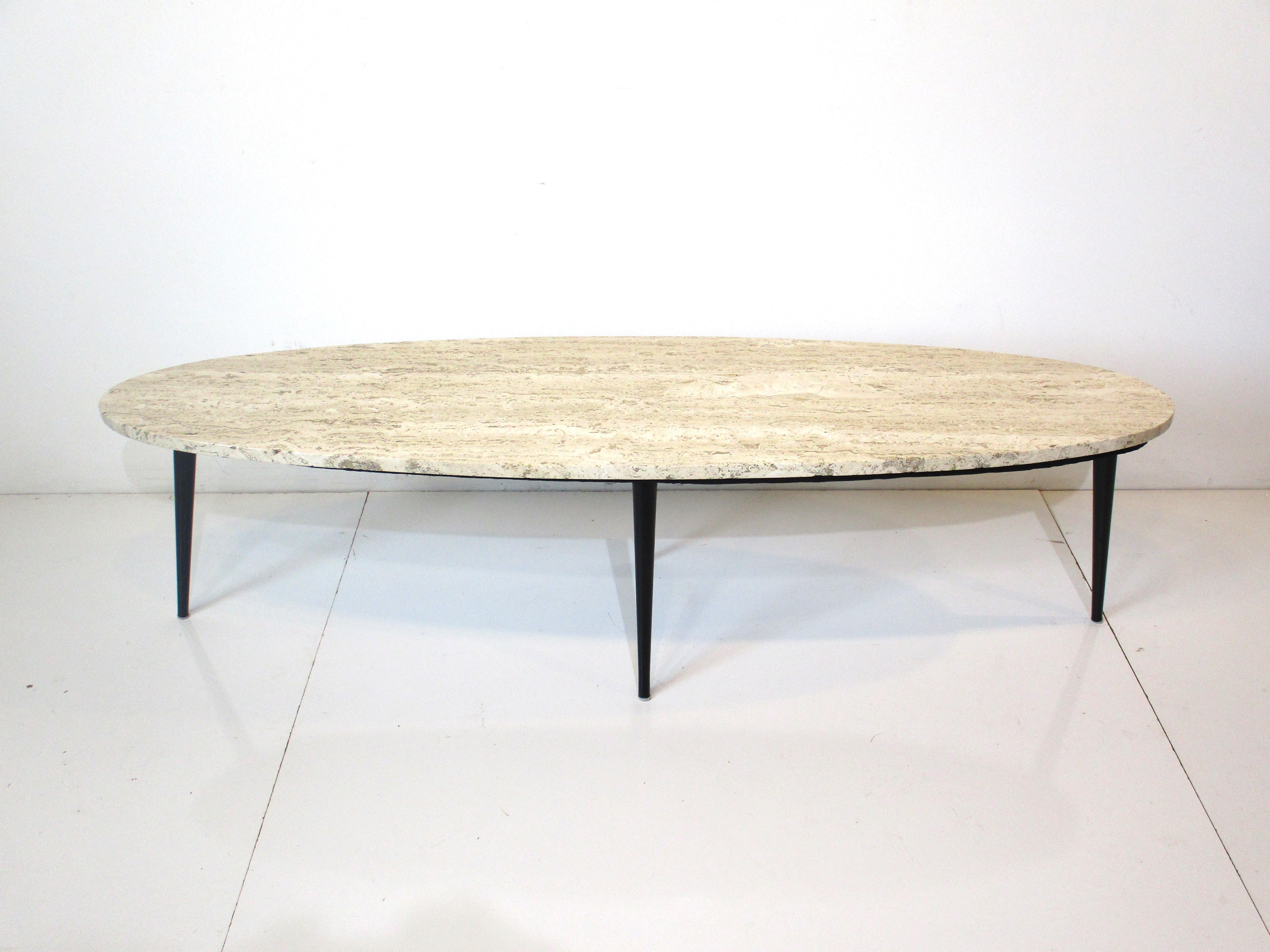 A wonderfully veined oval marble coffee table with satin black steel conical legs giving the piece a lighter feel and look . This two piece table is perfect for a longer sofa and would work with many styles and decors.