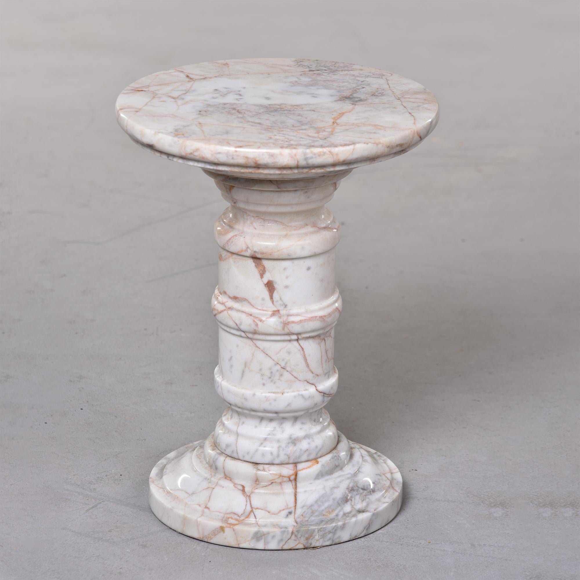 circa 1970s small Italian marble table or stand with turned pedestal base and round top. Marble is white with streaks of gray and apricot. Very good vintage condition with no flaws found - very minor scattered surface wear.