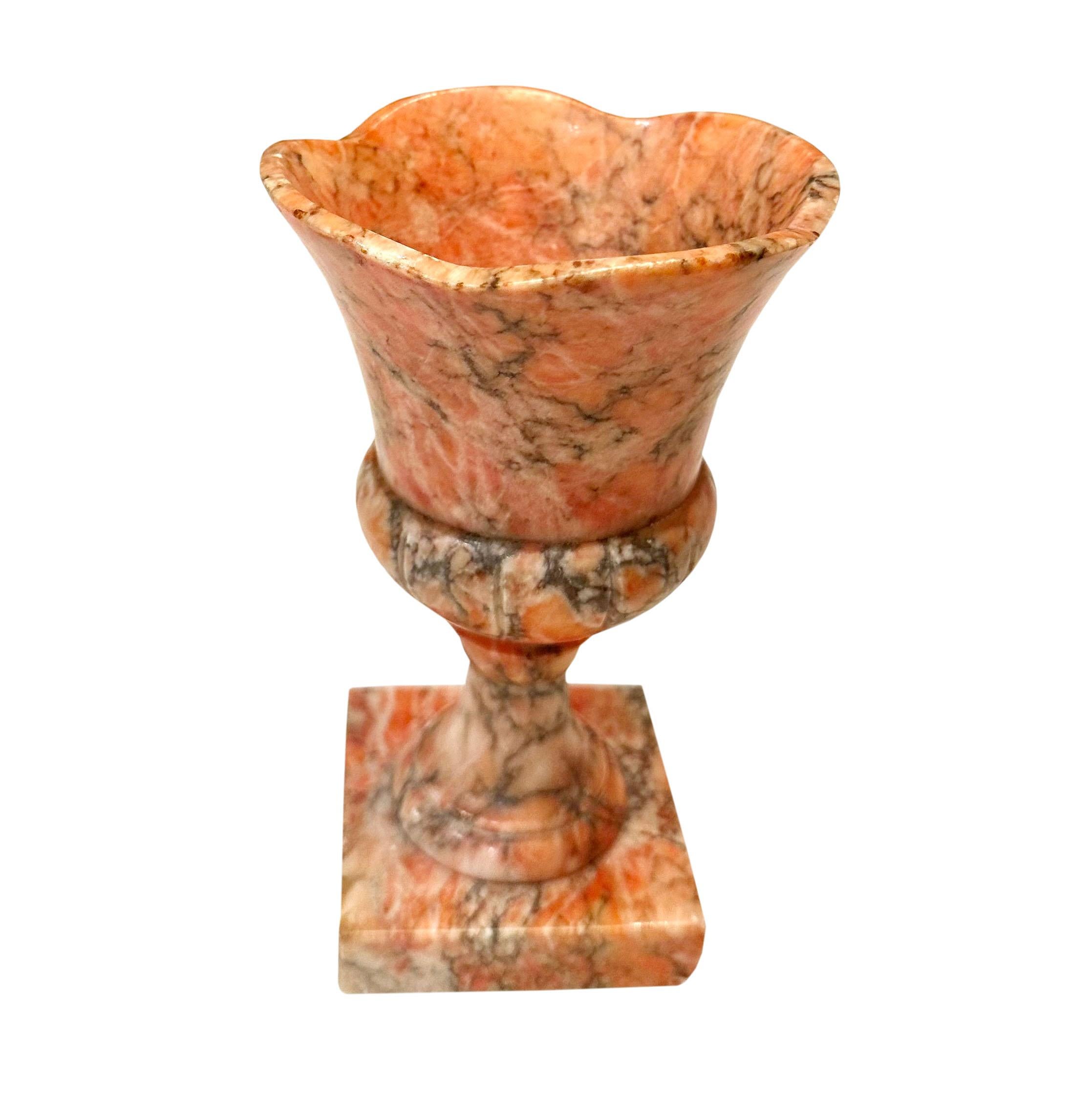 A lovely peach colored marble vase from Italy in the shaped of an urn with a ruffled rim on a square base. Circa 1940s.