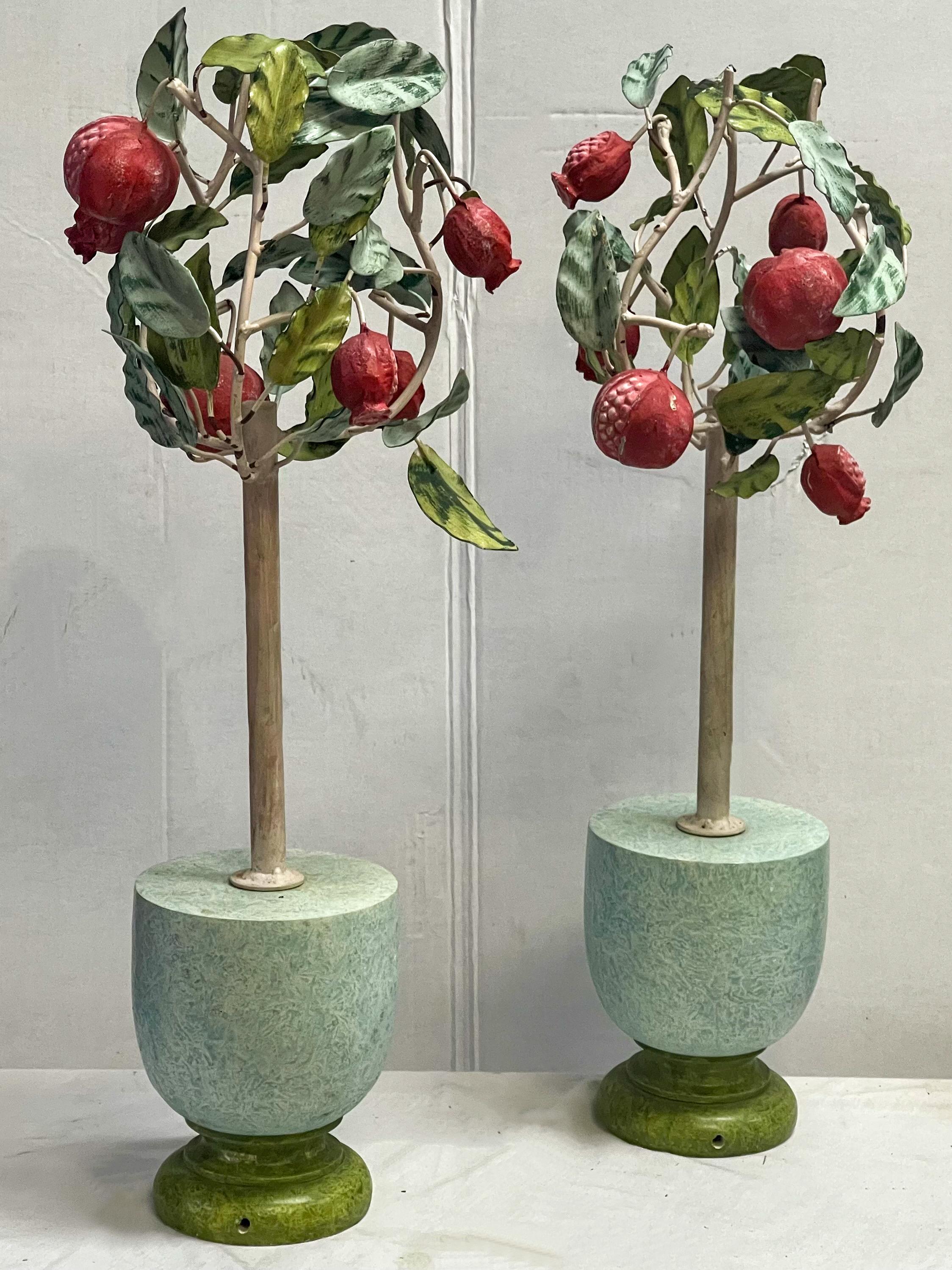 This is a lovely pair of Italian metal tole pomegranate topiaries in painted pots. The pots may have been a later addition. They are in good condition.