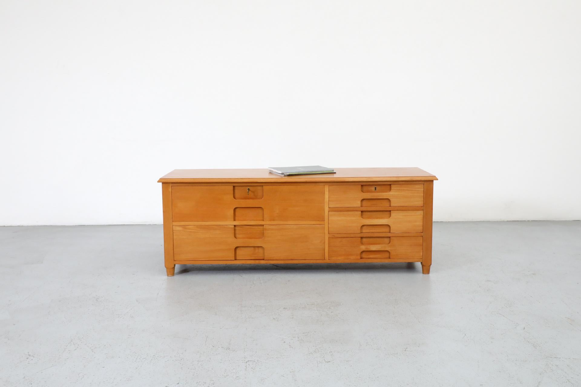 Mid-Century Italian mini credenza or dresser with stacked carved drawers. The handsomely crafted carvings on the drawer fronts ingeniously function as handles as well as decoration. The top 2 drawers are locking. Comes with Key. This piece is in