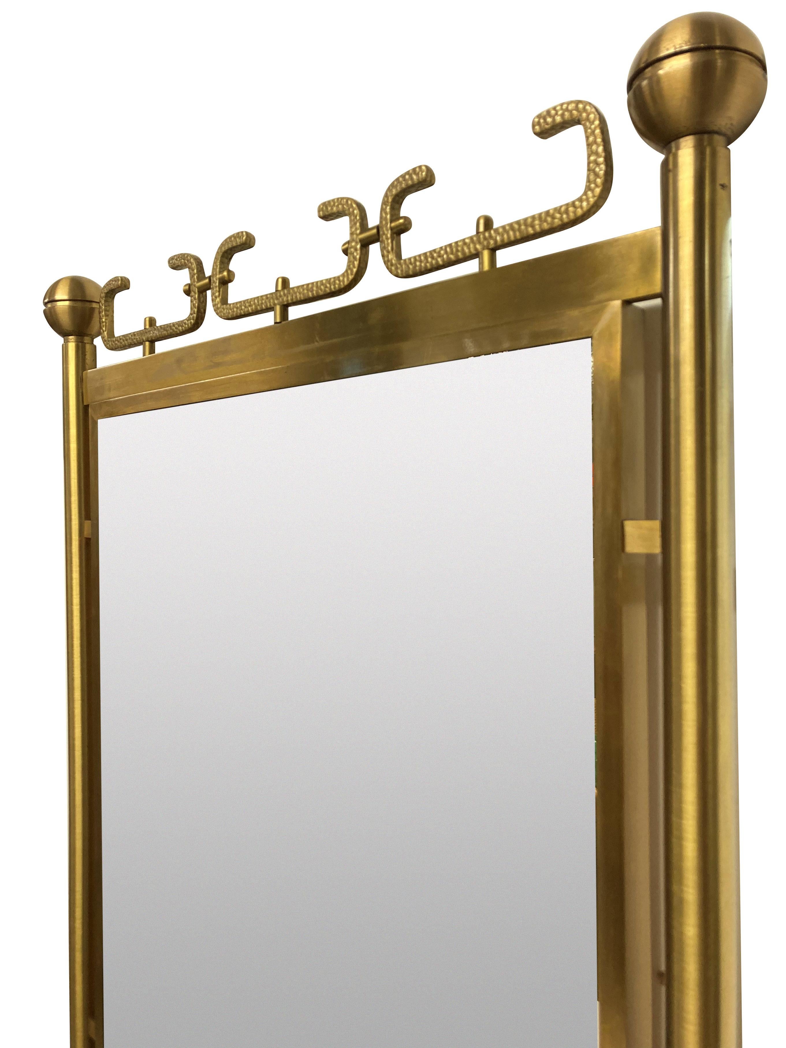An Italian mid-century mirror of interesting design in brushed brass.