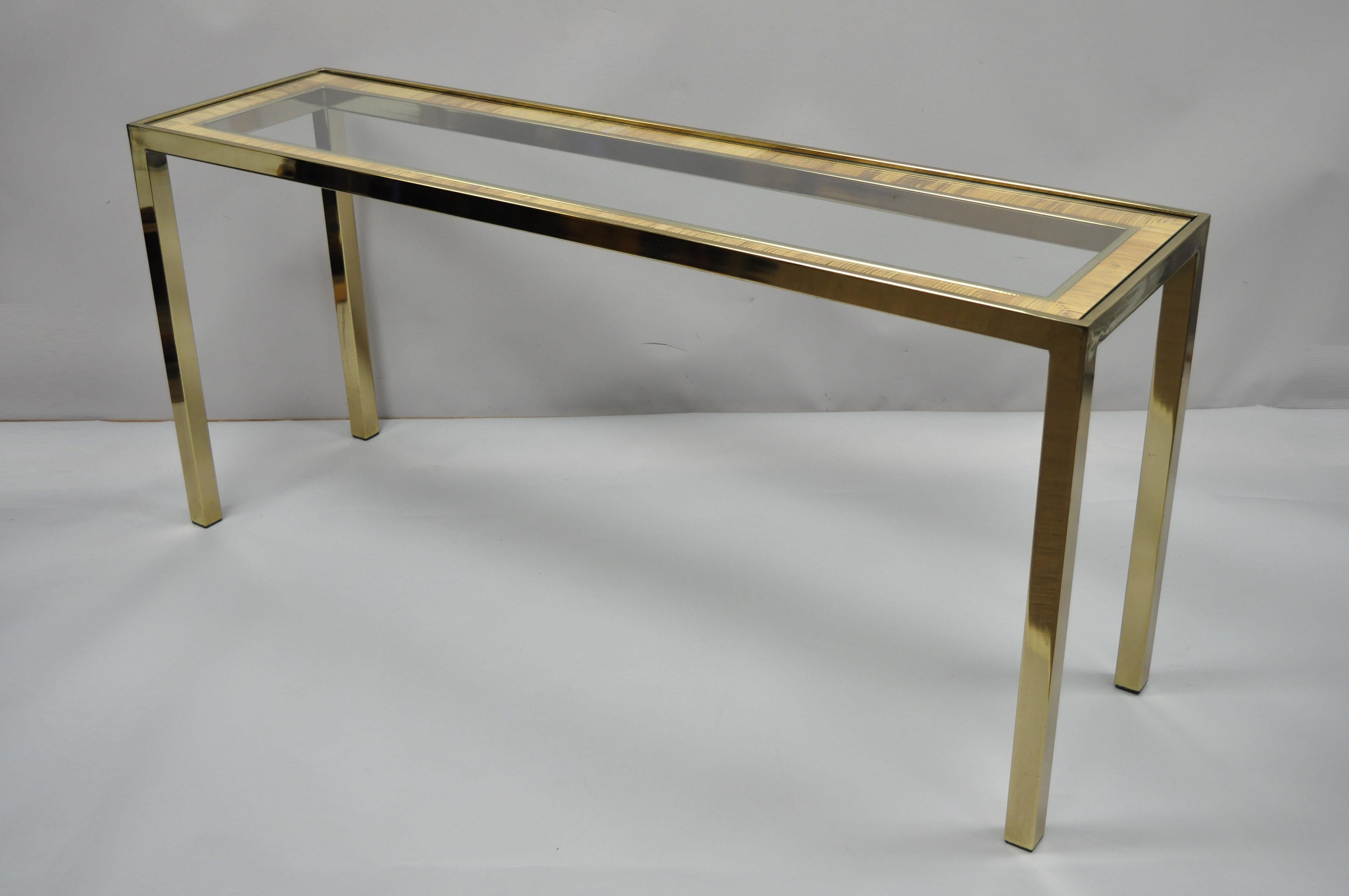 Vintage Mid-Century Modern Italian brass, glass, and rattan console table. Item features brass-plated metal frame, rattan wrapped border, inset glass top, clean modernist lines, great style and form. Similar to the quality and works of Milo Baughman