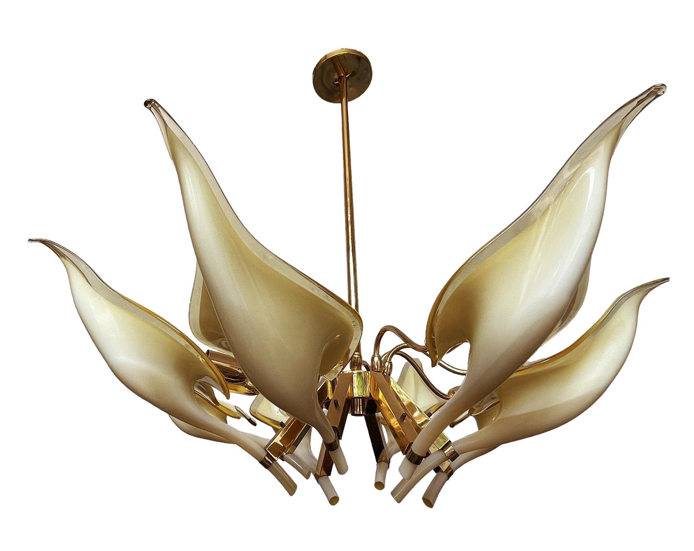 A lovely vintage chandelier designed by Franco Luce for Murano glass circa 1970's. It features handblown glass lily form shades with brass frame. Very good working condition. 