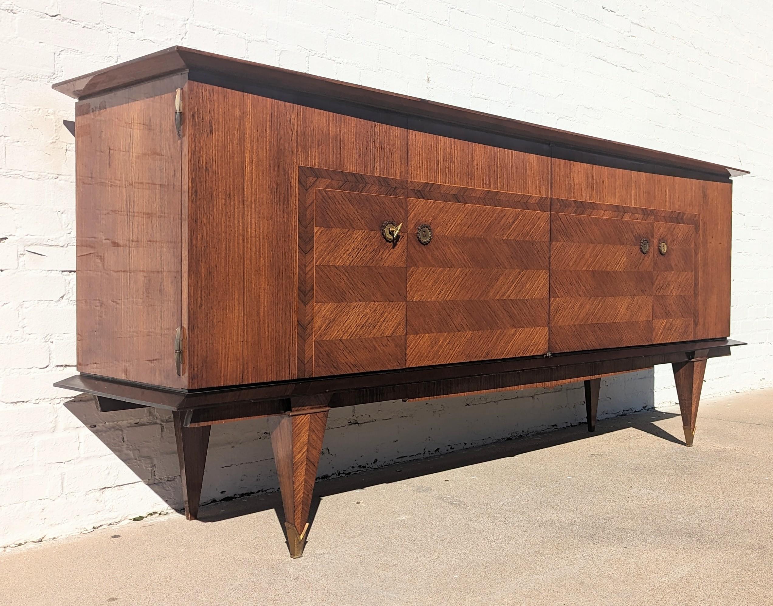 Beautiful, impressive, large statement piece. Modern Italian herringbone lacquered credenza leaves a stunning impression.
Above average condition and structurally sound. Does have some finish wear on top and some dings and discolorations on the top