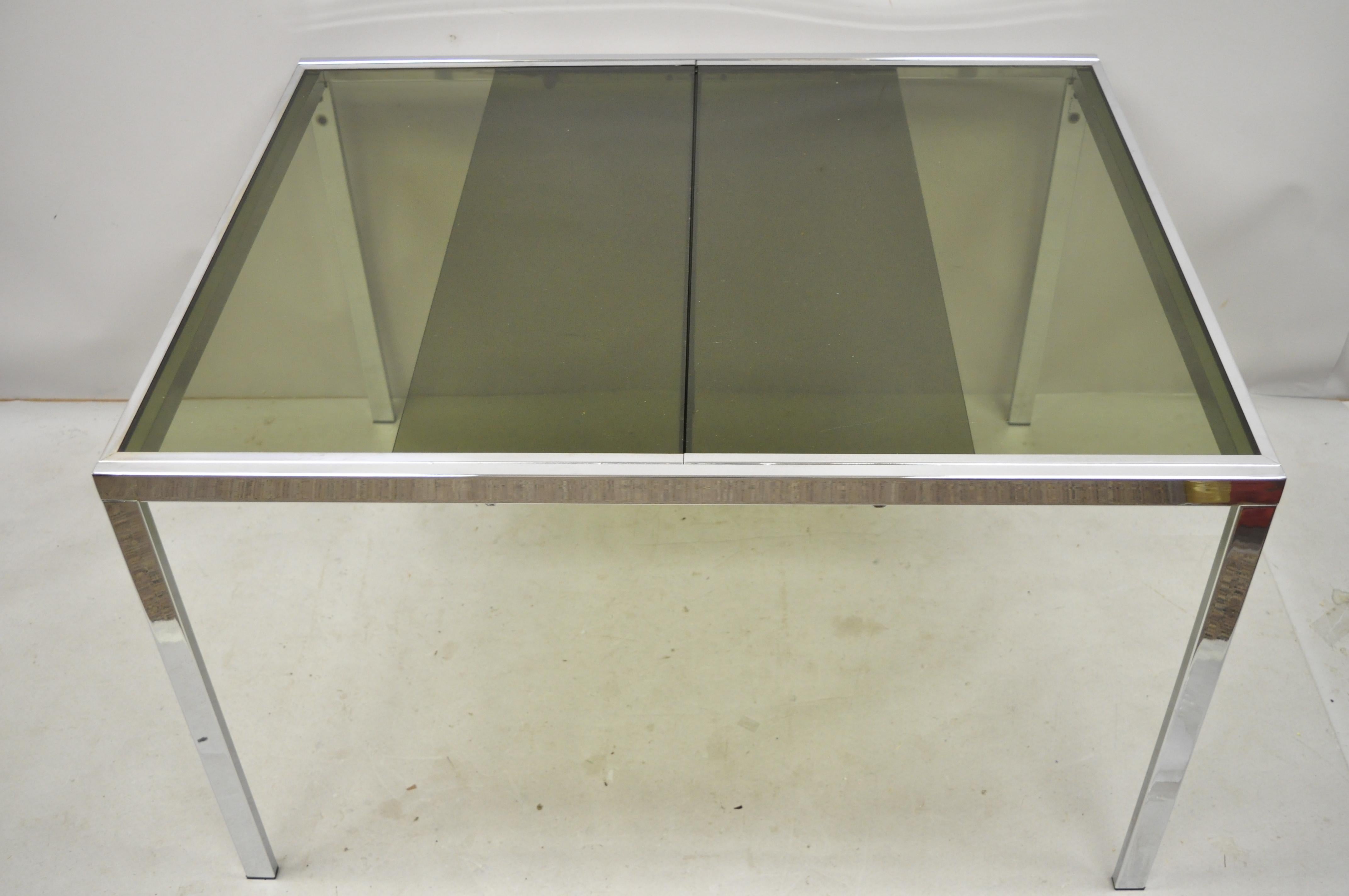 Midcentury Italian modern chrome and glass extension dining table. Item features a nice smaller size, chrome frame, extension sides with pop up leaf, original label, very nice vintage item, clean modernist lines, circa 1970s. Measurements: 28.5