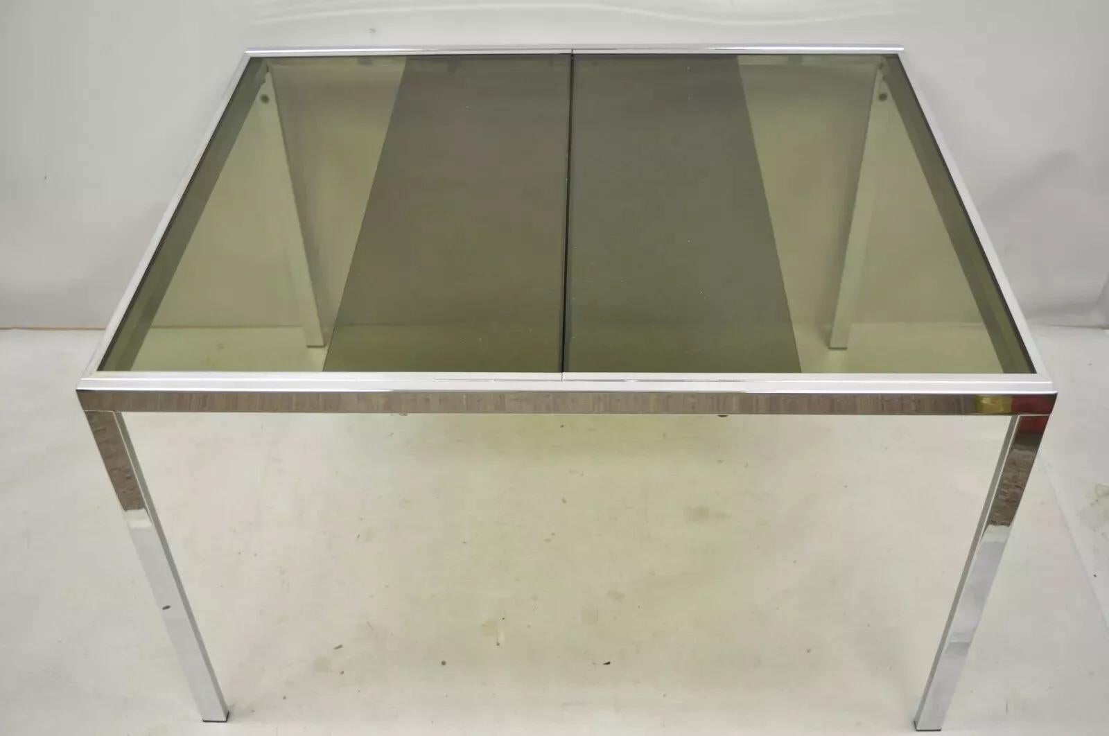 Mid Century Italian Modern Milo Baughman Chrome & Glass Extension Dining Table. Iem featured is a nice smaller size, chrome frame, extension sides with pop up leaf, original label, very nice vintage item, clean modernist lines. Circa Late 20th