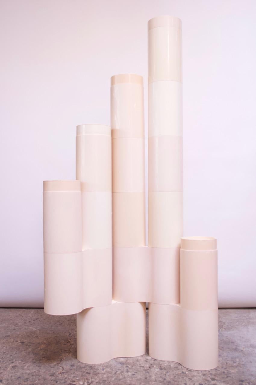 Unique set of circa 1960s-1970s Italian molded plastic cylinders, which can fit together in a variety of configurations to form a series of display stands. Some of the pieces are 'doubles,' which serve as connectors of the single pieces to form a