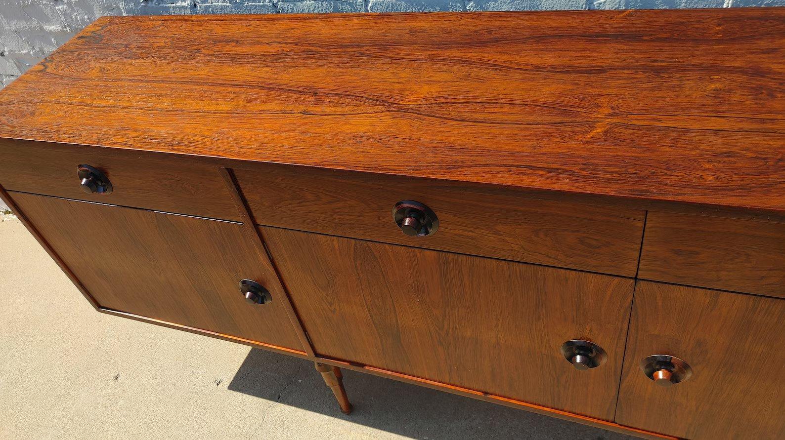 Mid Century Italian Modern Rosewood Sideboard
 
Above average vintage condition and structurally sound. Has some expected slight finish wear and scratching. Top has some discoloration rings. Front has a couple areas that look to be light sun fading.