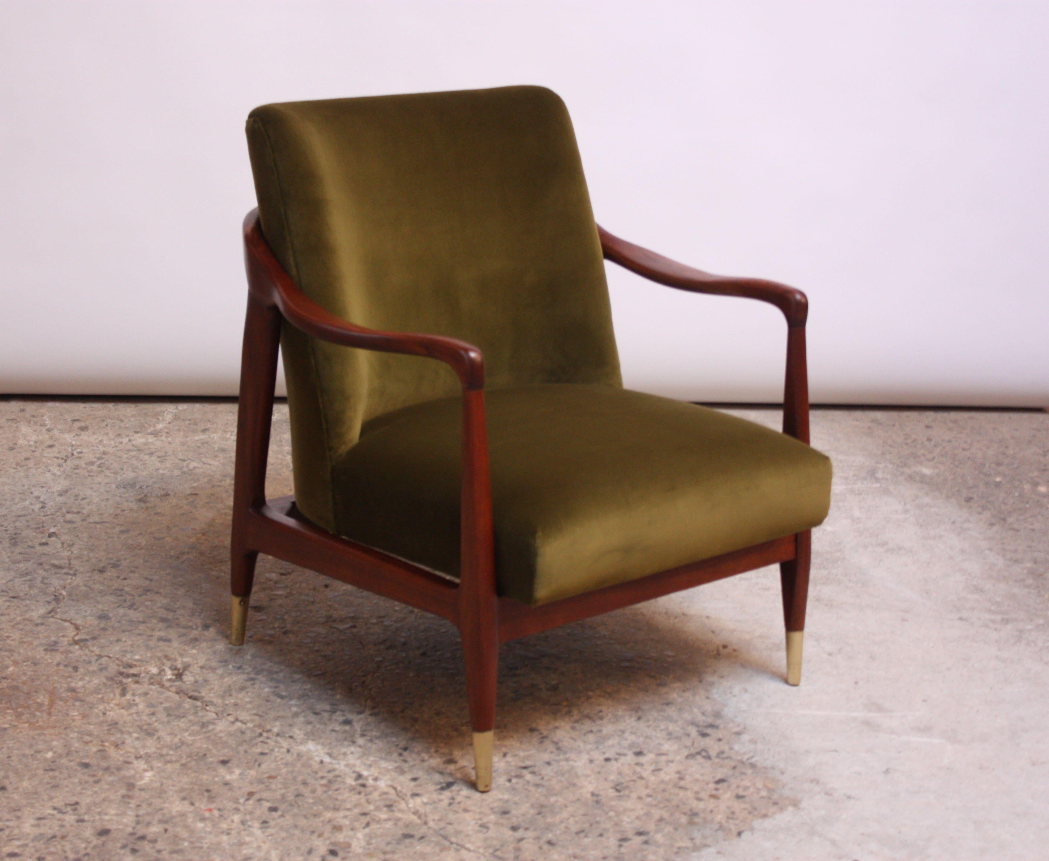 Exquisite, diminutive 1950s Italian lounge chair featuring a sculpted walnut frame and brass sabots. Newly reupholstered in a moss green velvet. Frame has been refinished and sabots have been polished, but minor wear remains to brass, as pictured.