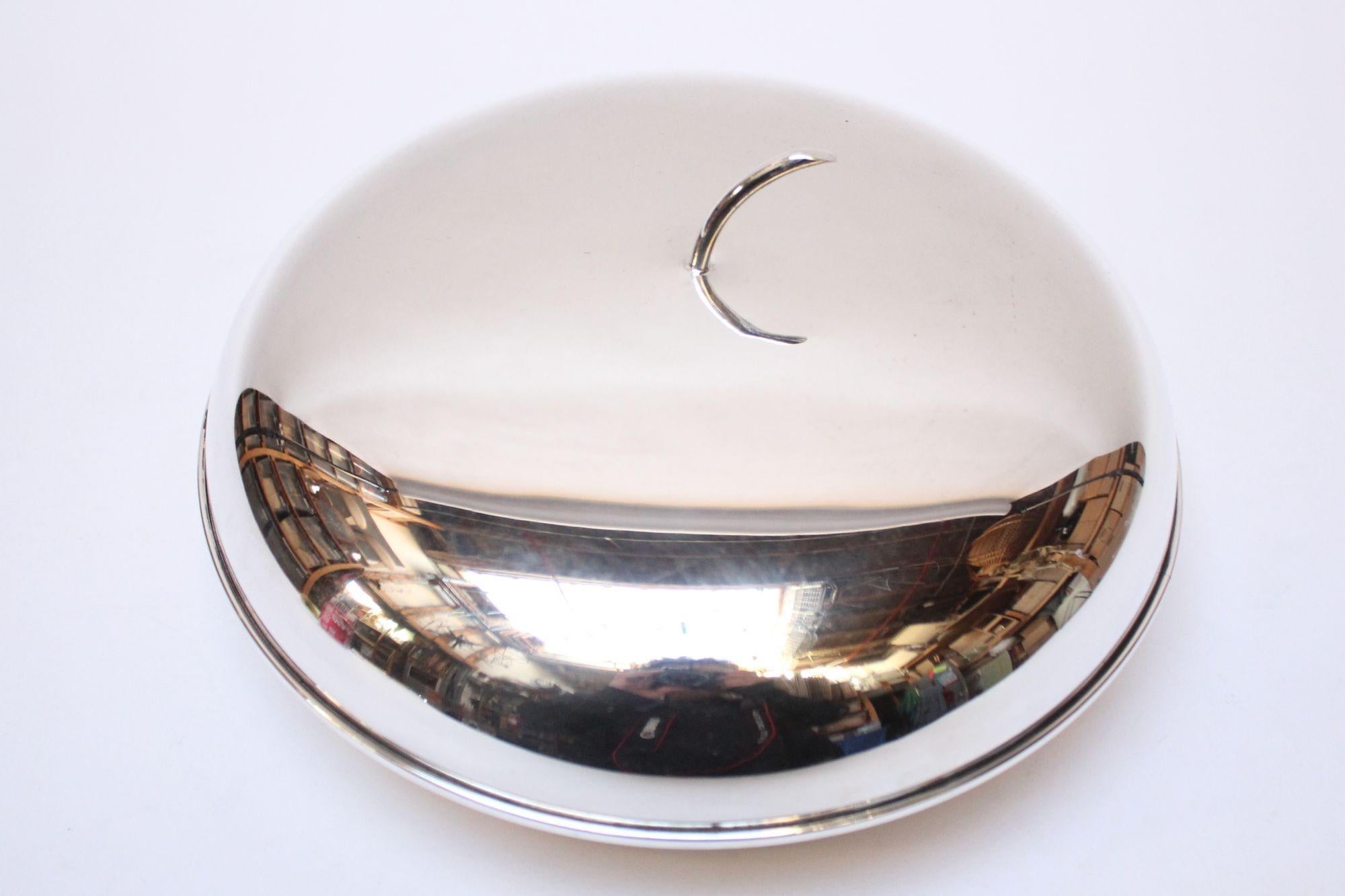 Italian silver-plated round snack/candy/serving dish with lidded top (ca. 1960s, Italy).
This is a shorter, uninsulated version of fruit and vegetable-formed ice buckets made in Italy and France in the mid-20th century.
Though shallow, this piece