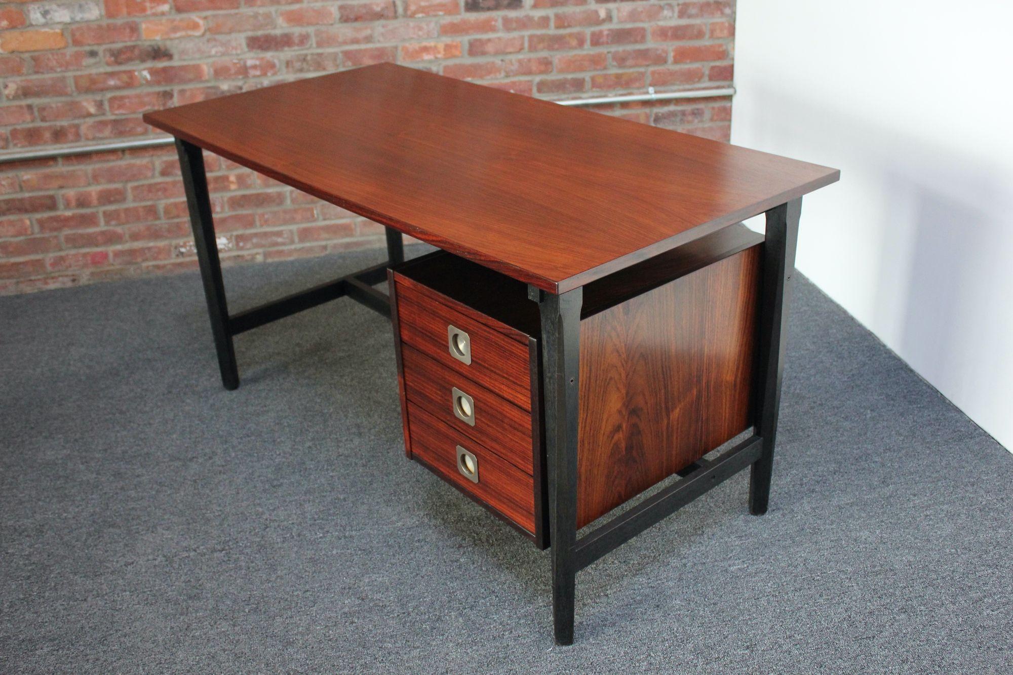 Single-pedestal rosewood desk with ebonized legs and chrome-plated brass recessed pulls by Stildomus (ca. 1950s, Italy). 
Features three dove-tailed drawers with interior dimensions measuring: H: 3.5