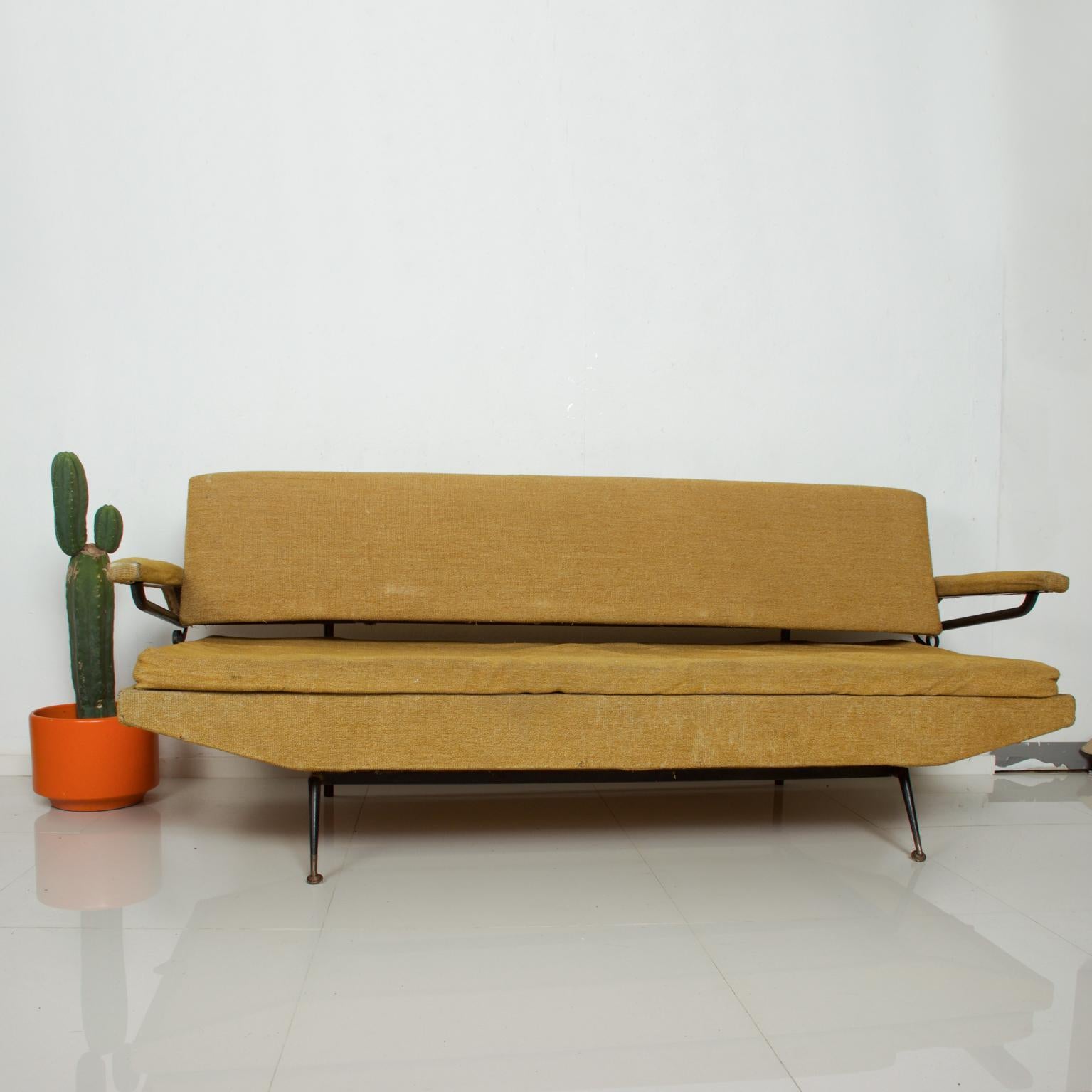 We are pleased to offer for your consideration. A vintage Italian sofa-daybed inspired-design by Osvaldo Borsani.

No label present from the maker. Made in Italy, circa 1950s. Original upholstery. Fair condition. The arm can be lifted giving room