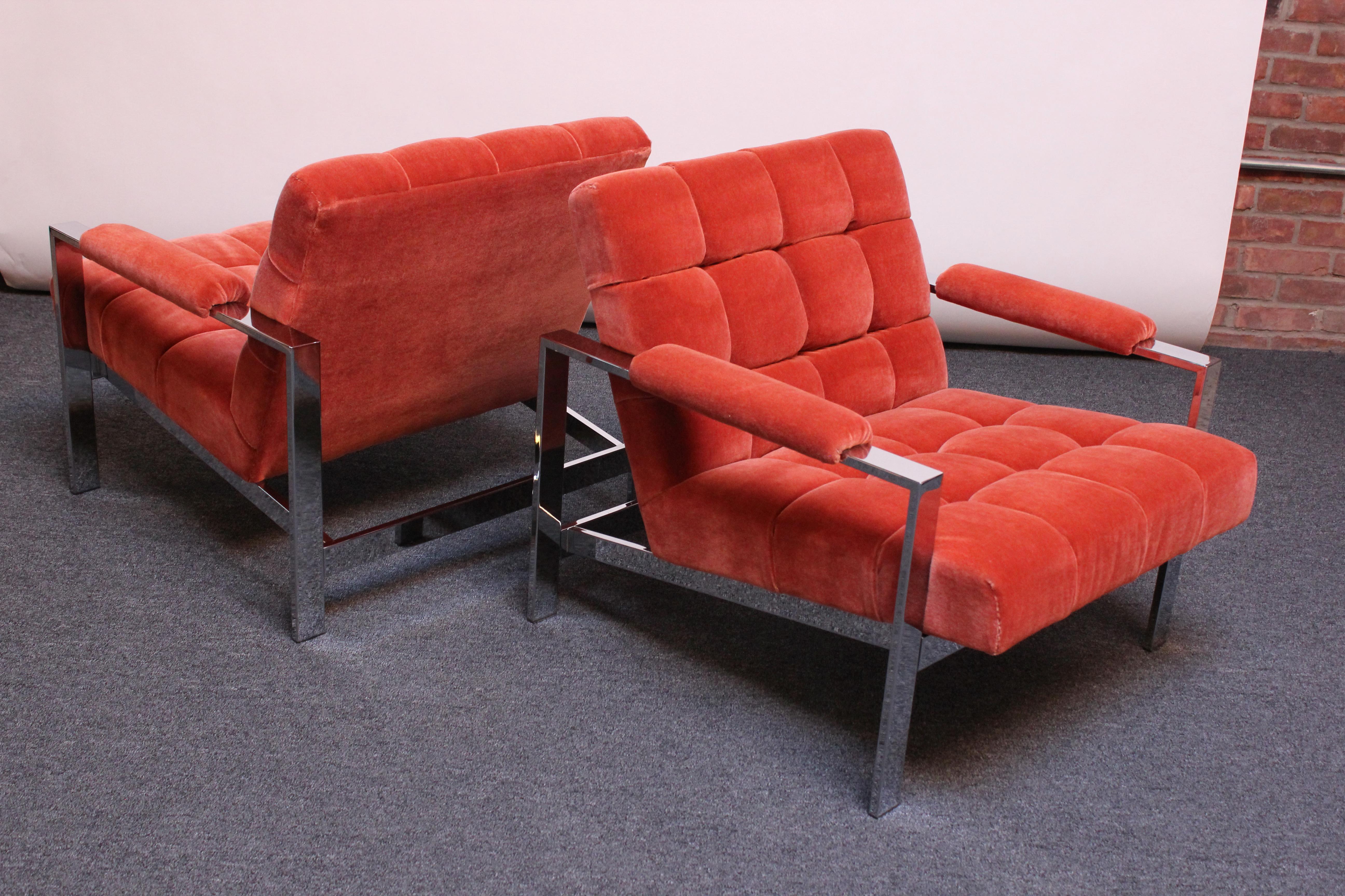 Luxurious pair of Mid-Century Modern arm chairs with polished chrome frames and tufted back and seat (reminiscent of the flat bar lounge chairs by Milo Baughman but an Italian design, as indicated by the label). 
Elegant profile with sharp, slanted