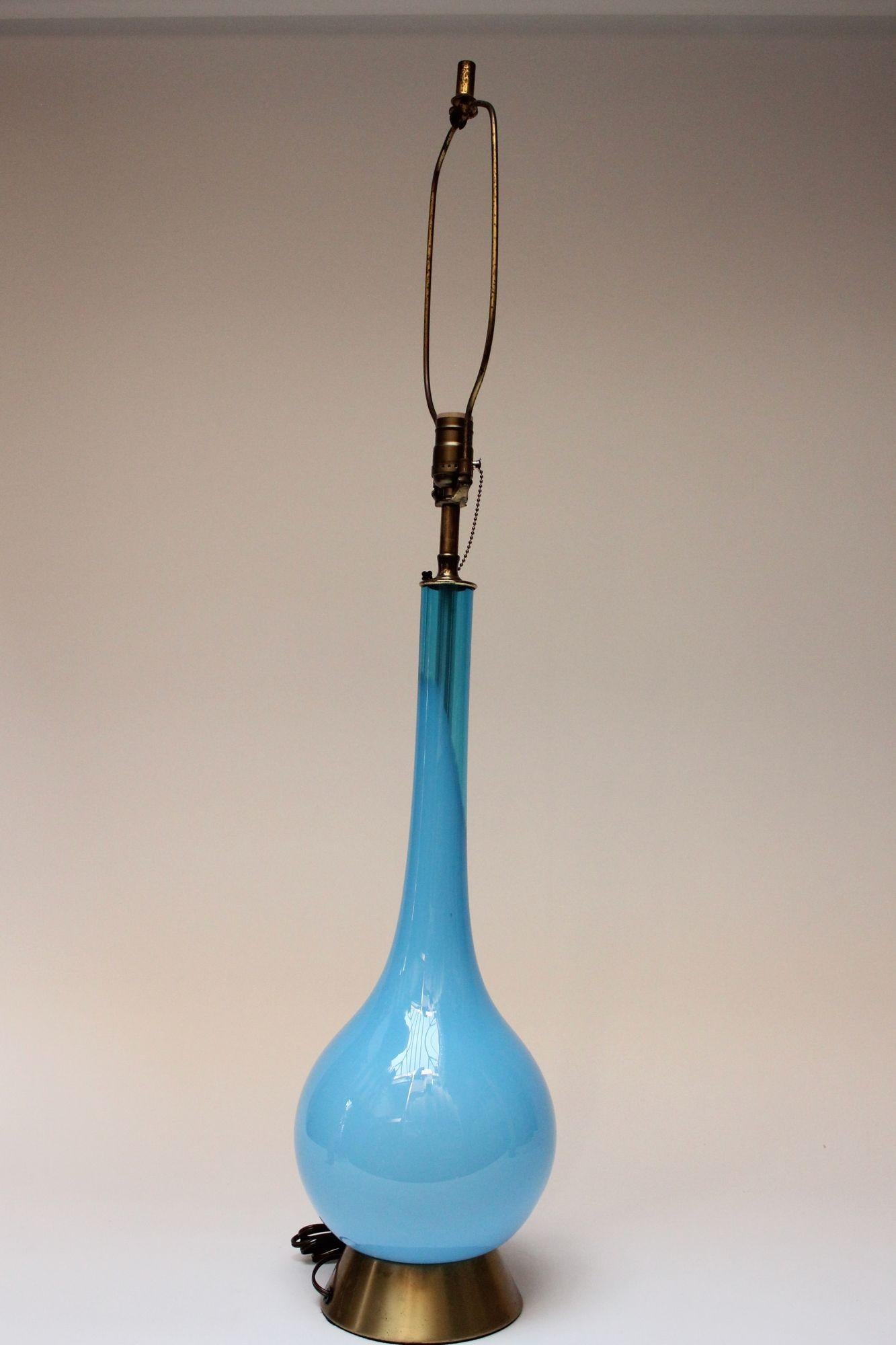Vintage blown glass lamp in turquoise supported by a brushed brass base (circa 1960s, Italy).
Interesting composition with most of the lamp appearing to be opaline, but a section of the neck bearing a translucence, which provides a view of the