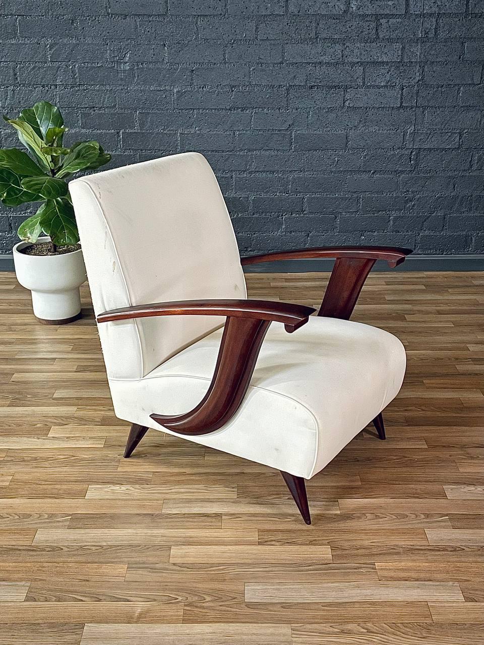 Condition: New Upholstery Recommended 

This Mid-Century Italian Modernist Lounge Chair, dating to the 1950s, is a striking example of Italian craftsmanship and sculptural design. Its bold mahogany arms, elegantly curved in a dramatic sweep, create
