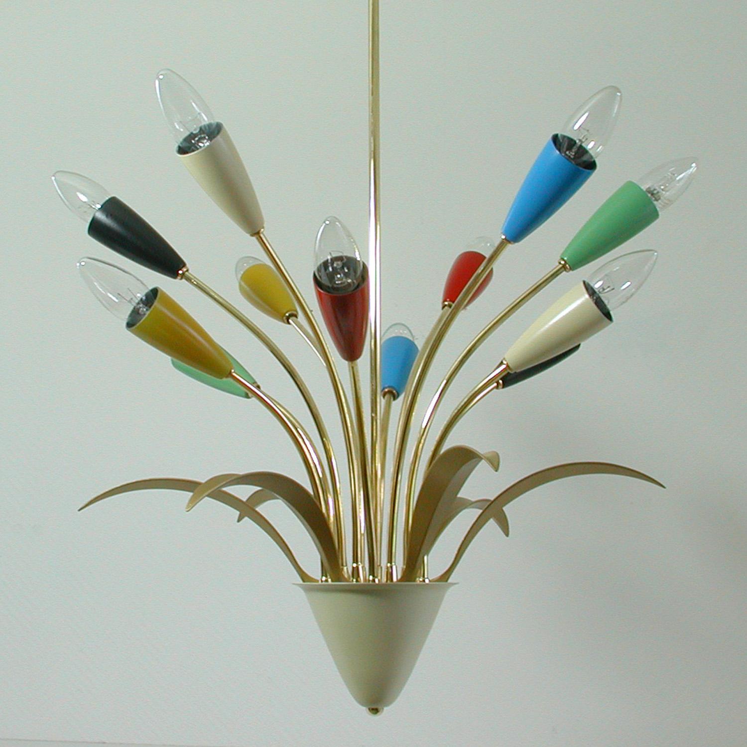 This multi-color Sputnik chandelier was made in Italy in the 1950s and is attributed to Arredoluce, Monza. 

It has got 12 bakelite bulb holders which request an E14 bulb each. The bulb holders have got the color cream, red, blue, light green and