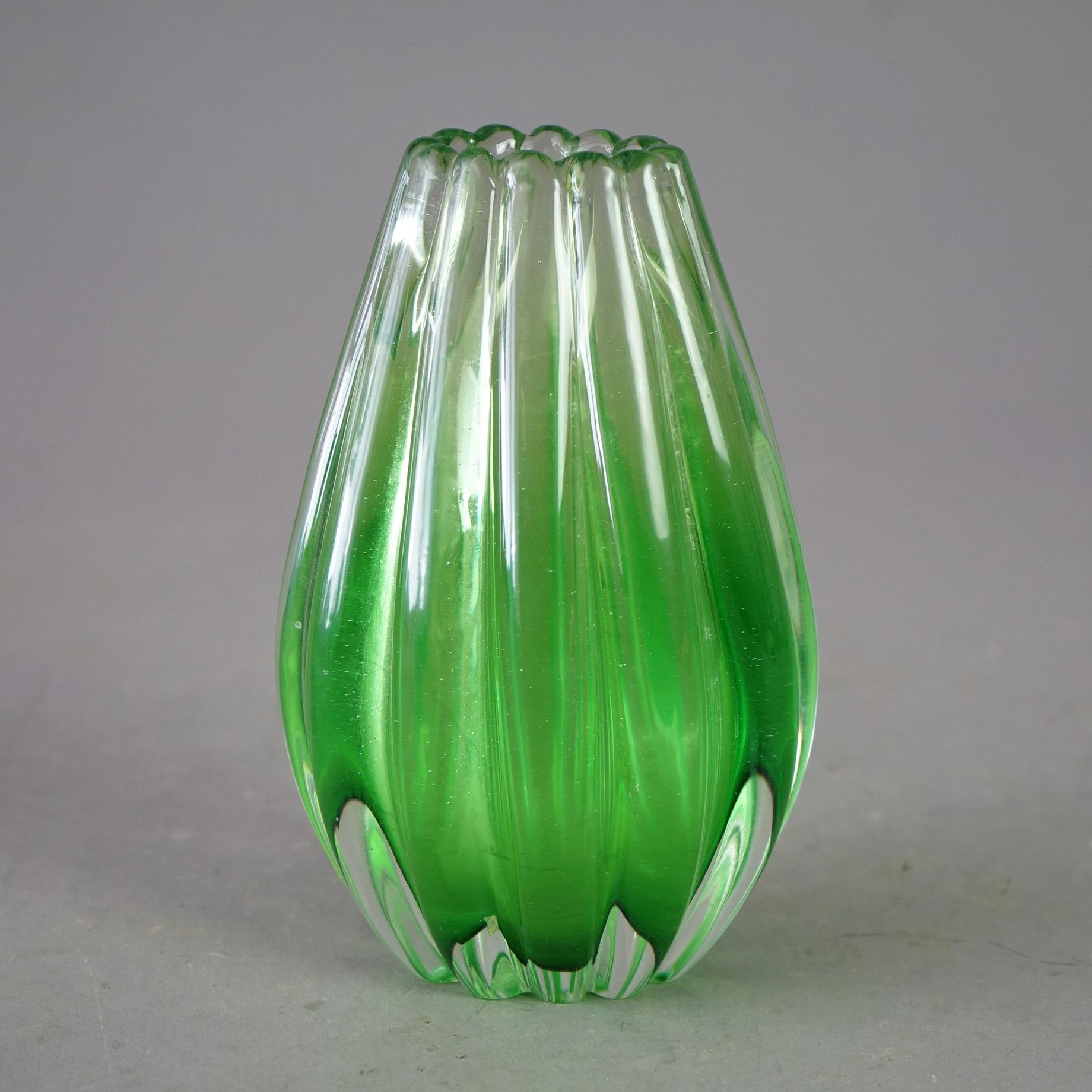 A Mid Century Italian vase in the manner of Murano Barovier & Toso offers colorless cased emerald green art glass construction, circa 1950

Measures - 7