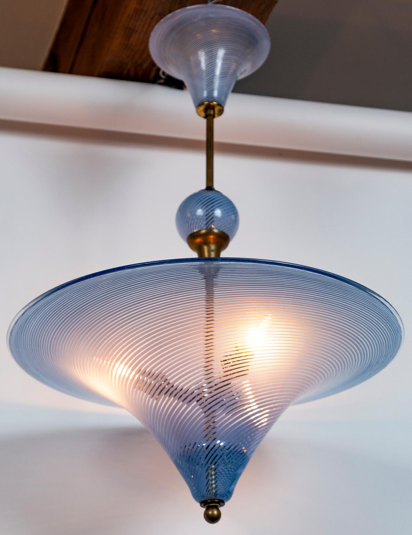 Charming and unique blue swirl pendant with whimsical stem with matching ball and canopy. The glass blown ball may be placed anywhere along the stem and the canopy may be modified to install directly into the ceiling or an additional chain and