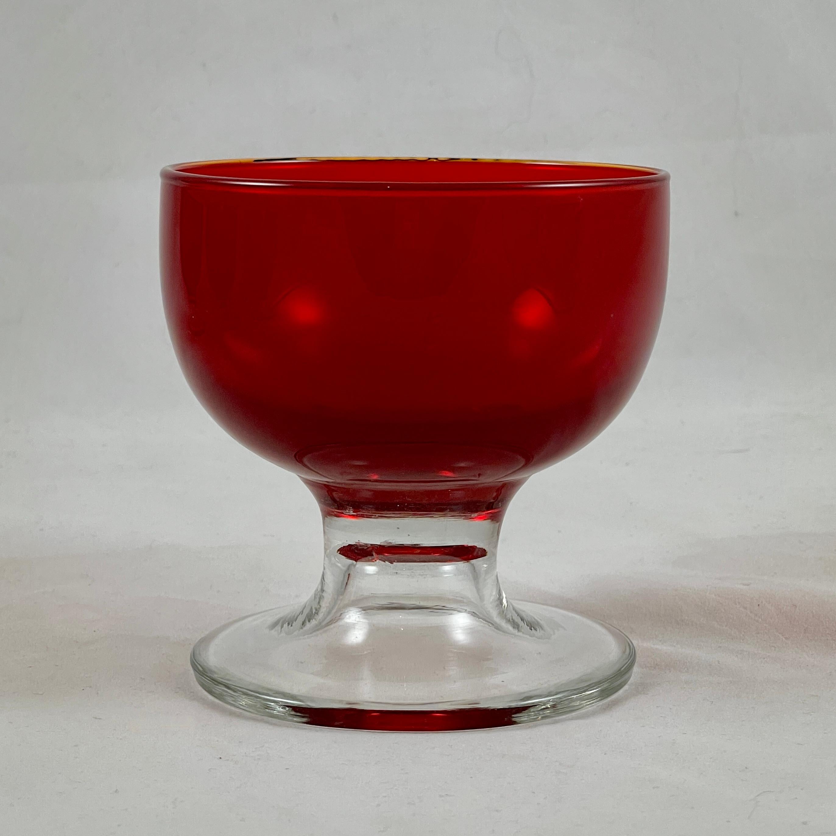 From the Venetian region of Northern Italy, a set of six Murano glass coupes or sherbets, circa 1950-1960.

Ruby Red bowls are fused to heavy colorless glass pedestal bases in a distinctive Italian mid-century design. Still showing the original