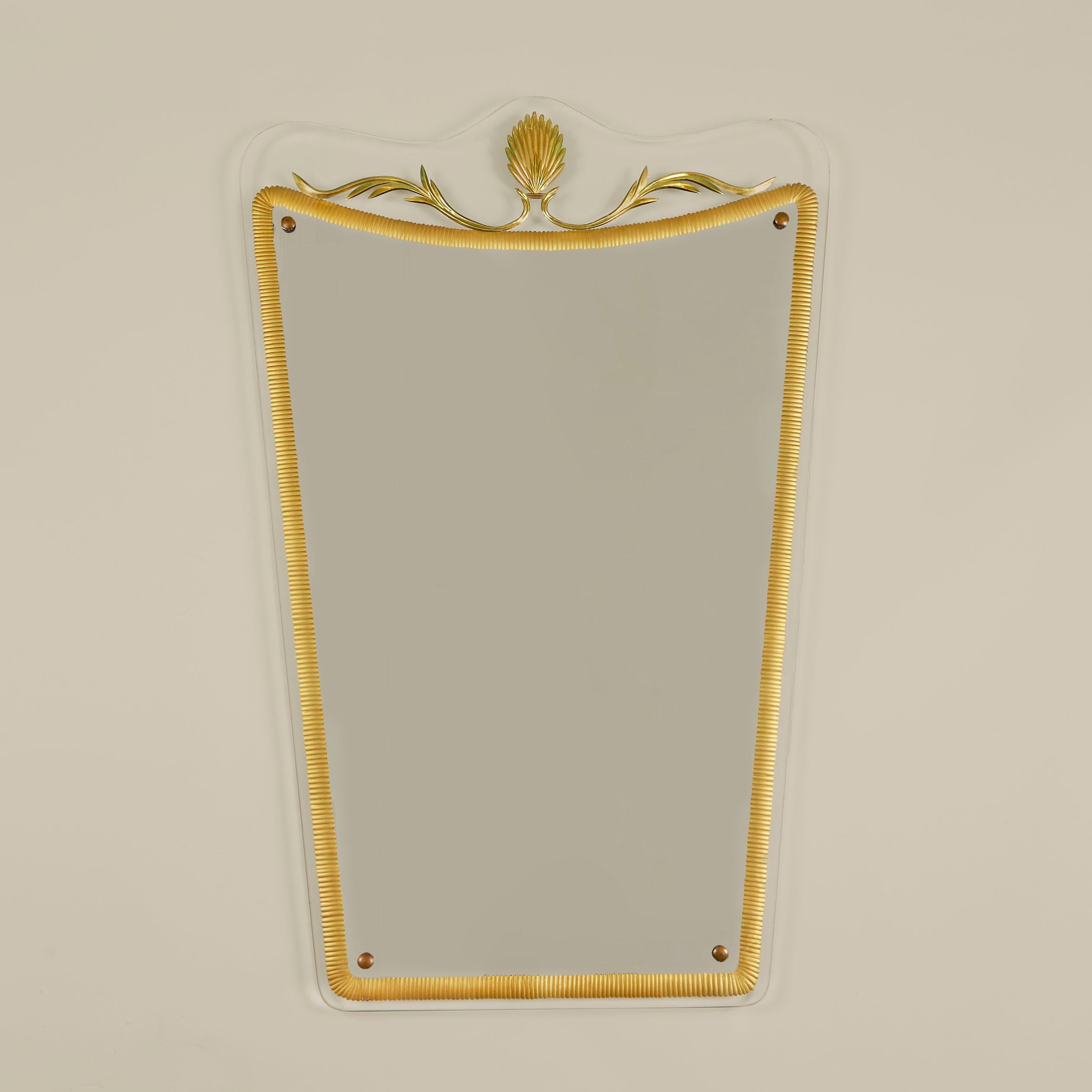 Chic Italian Murano glass shaped frame supports detailed gilt surround mirror with decorative swirl top.
