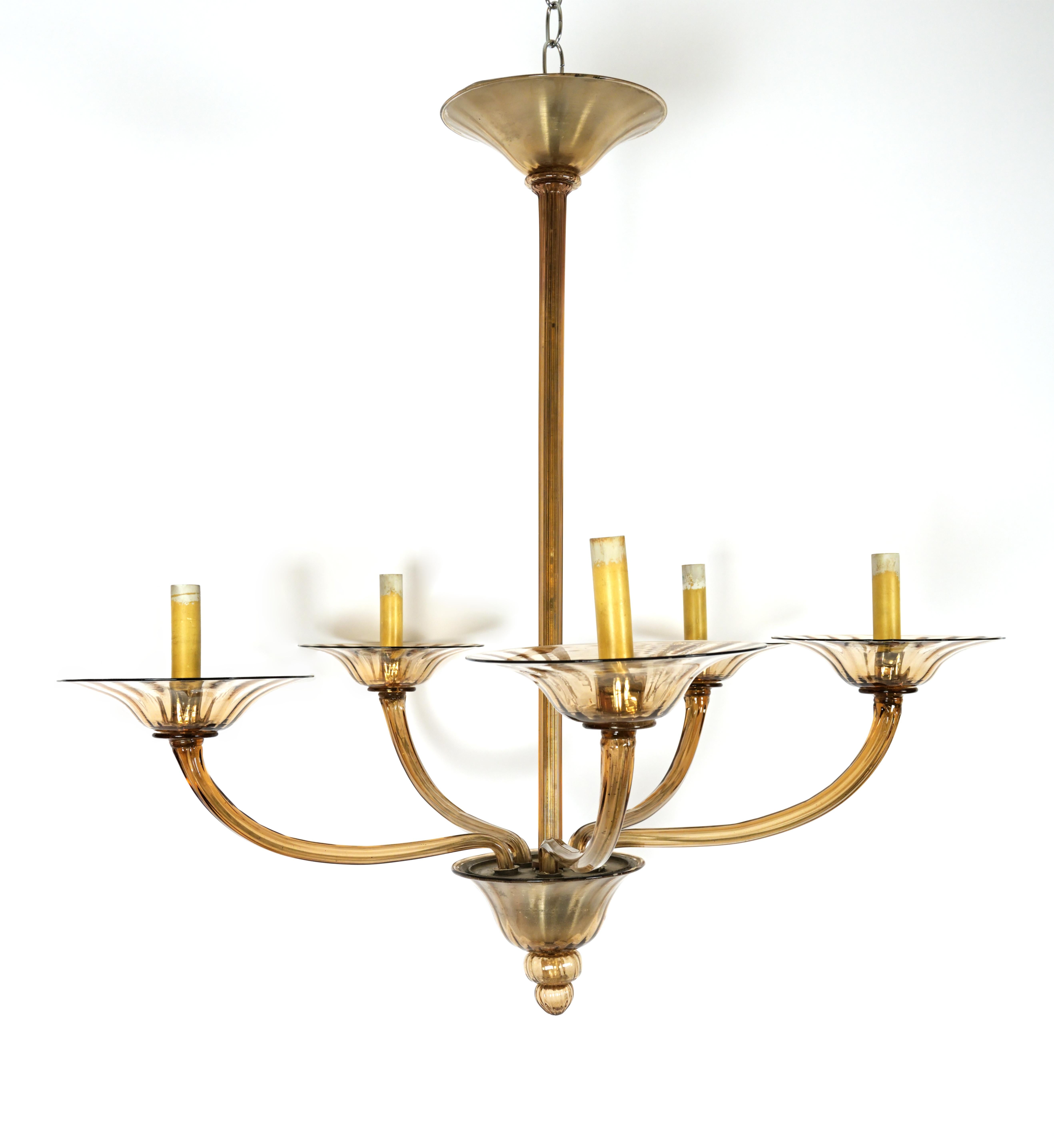 An Italian hand blown smokey amber Murano glass chandelier with five arms issuing from the hand blown dish center below a stem with cylindrical glass elements covering the stem. Each arm having bowl with glass drop on underside.

Please note, the